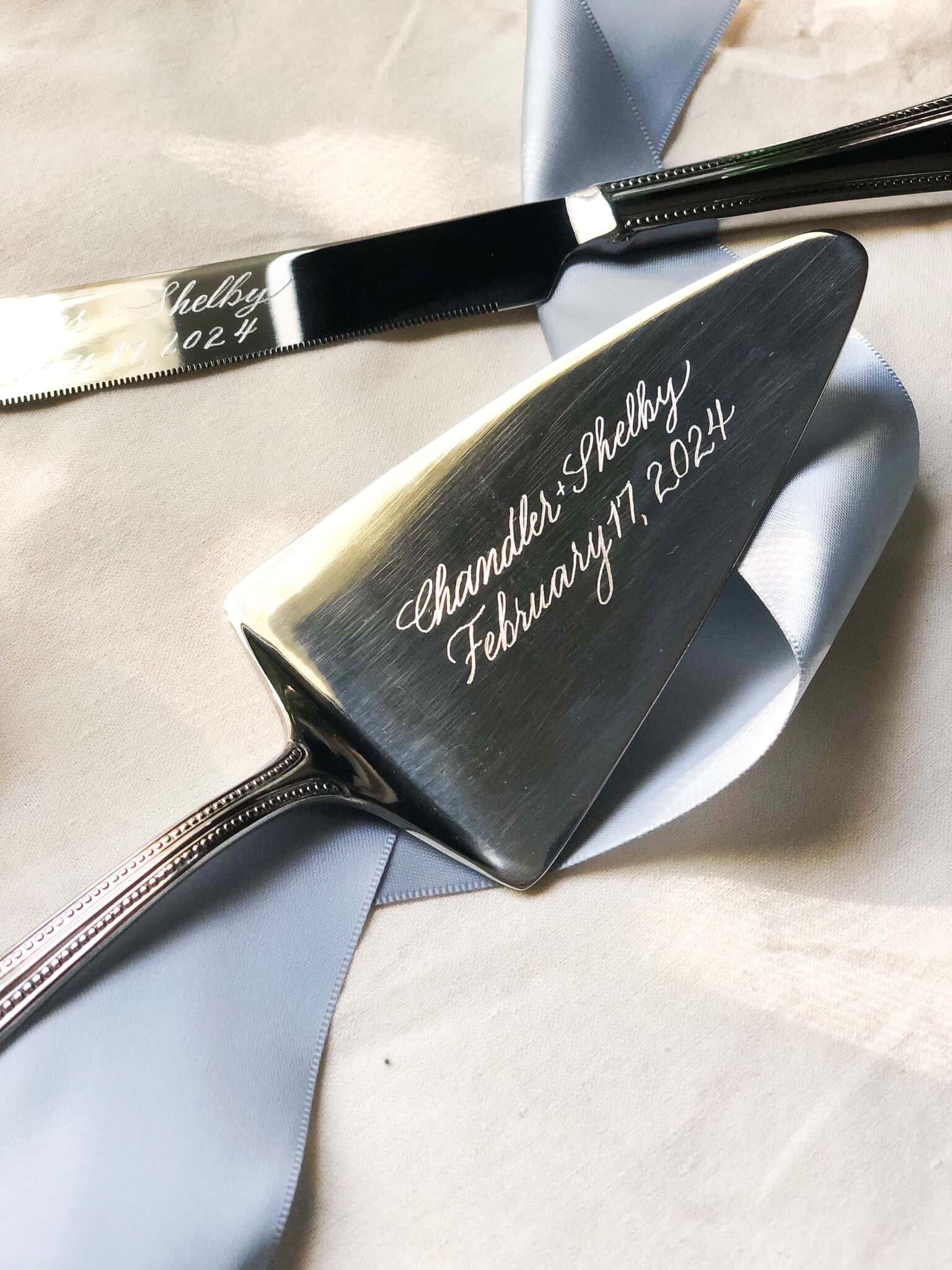 calligraphy engraved cake knife set with blue silk ribbon