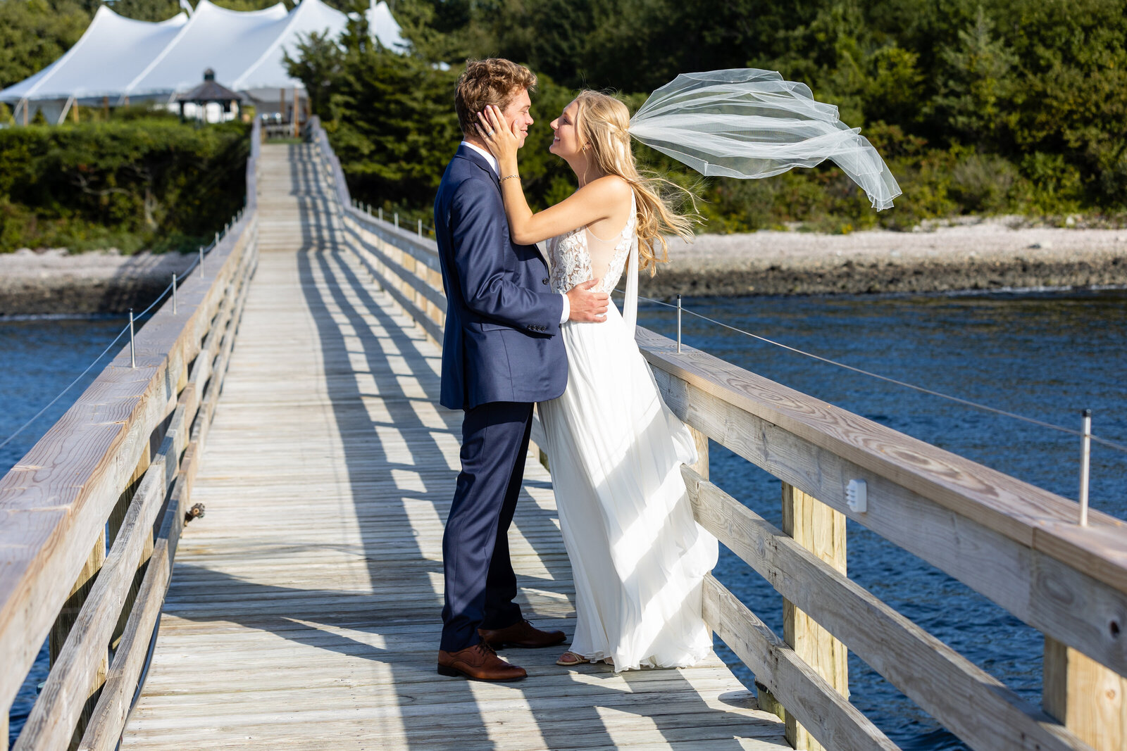 bride and groom pose on dock in nantucket