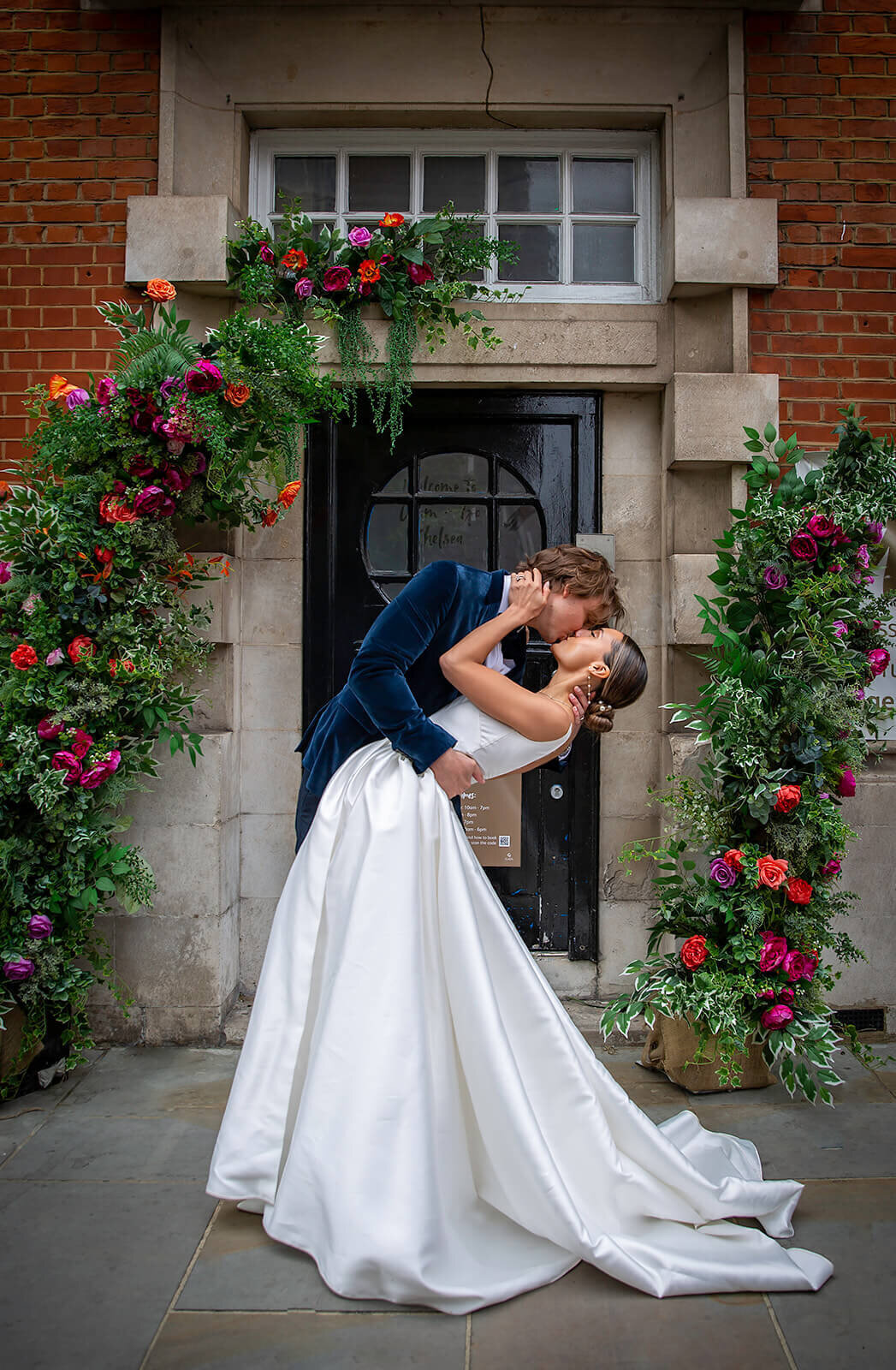 Bride and groom having a dip kiss infront of Chelsea Registry Office