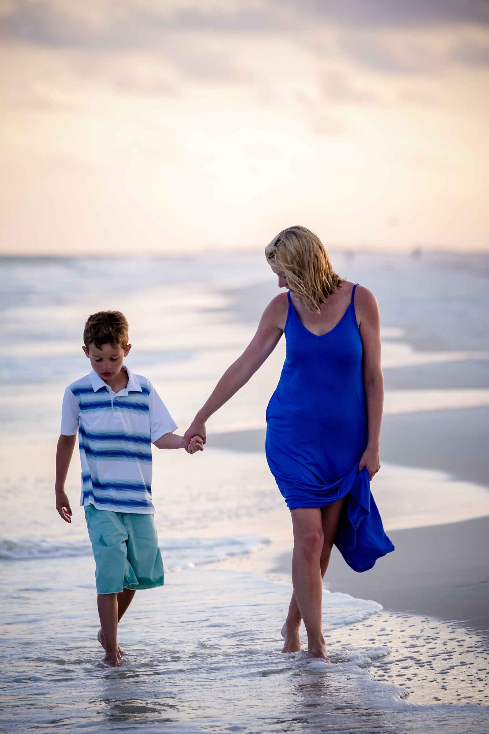 Pensacola Photography session during family vacation on Pensacola Beach . Mother walking with son at sunset.