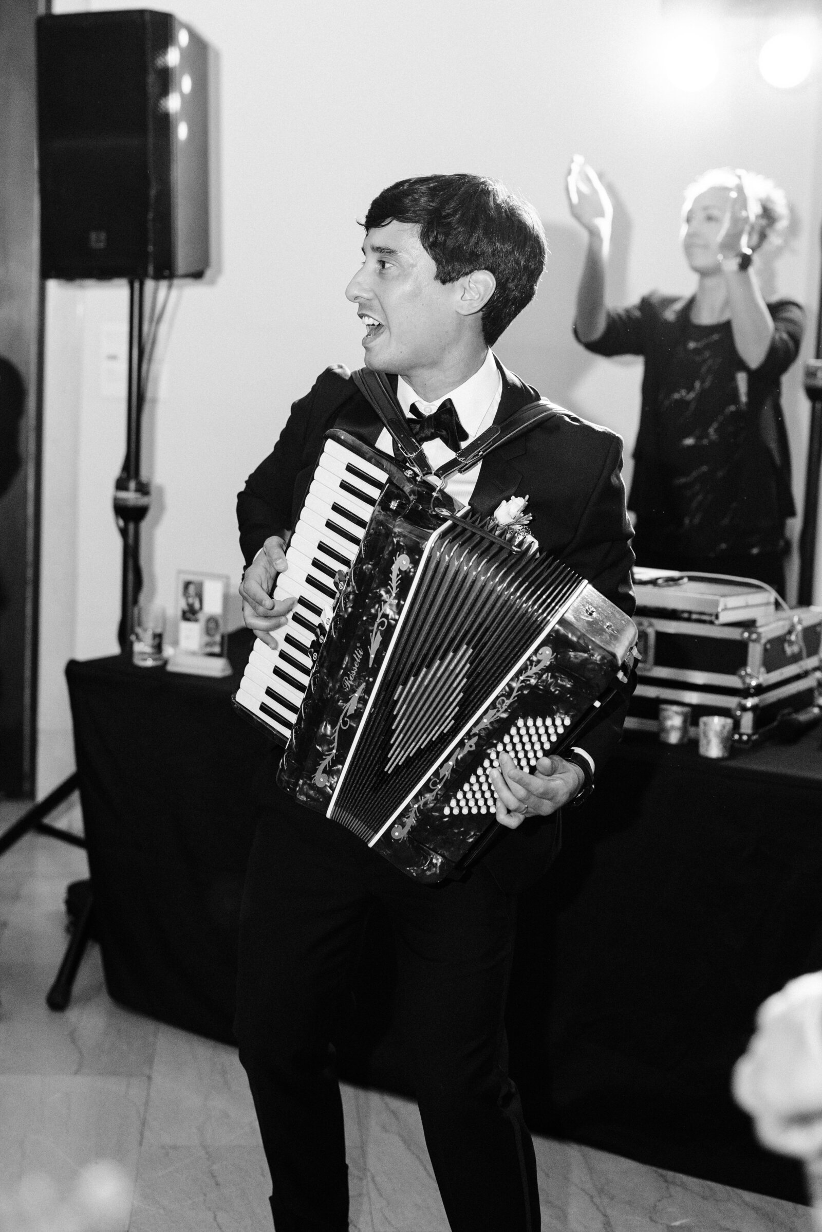 The groom is playing the accordion at the Minneapolis Institute of Art