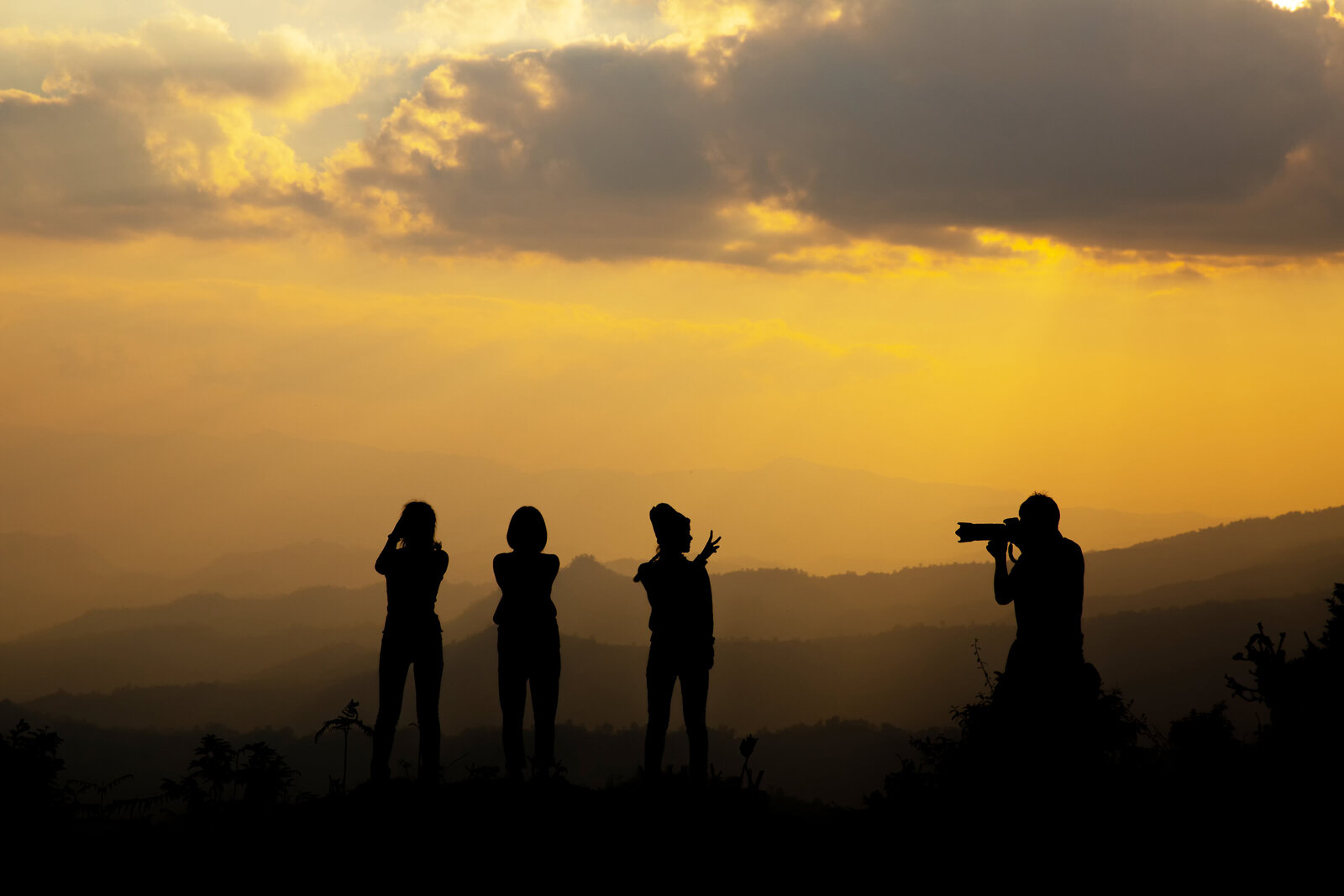 group-happy-people-photographing-mountain-sunset