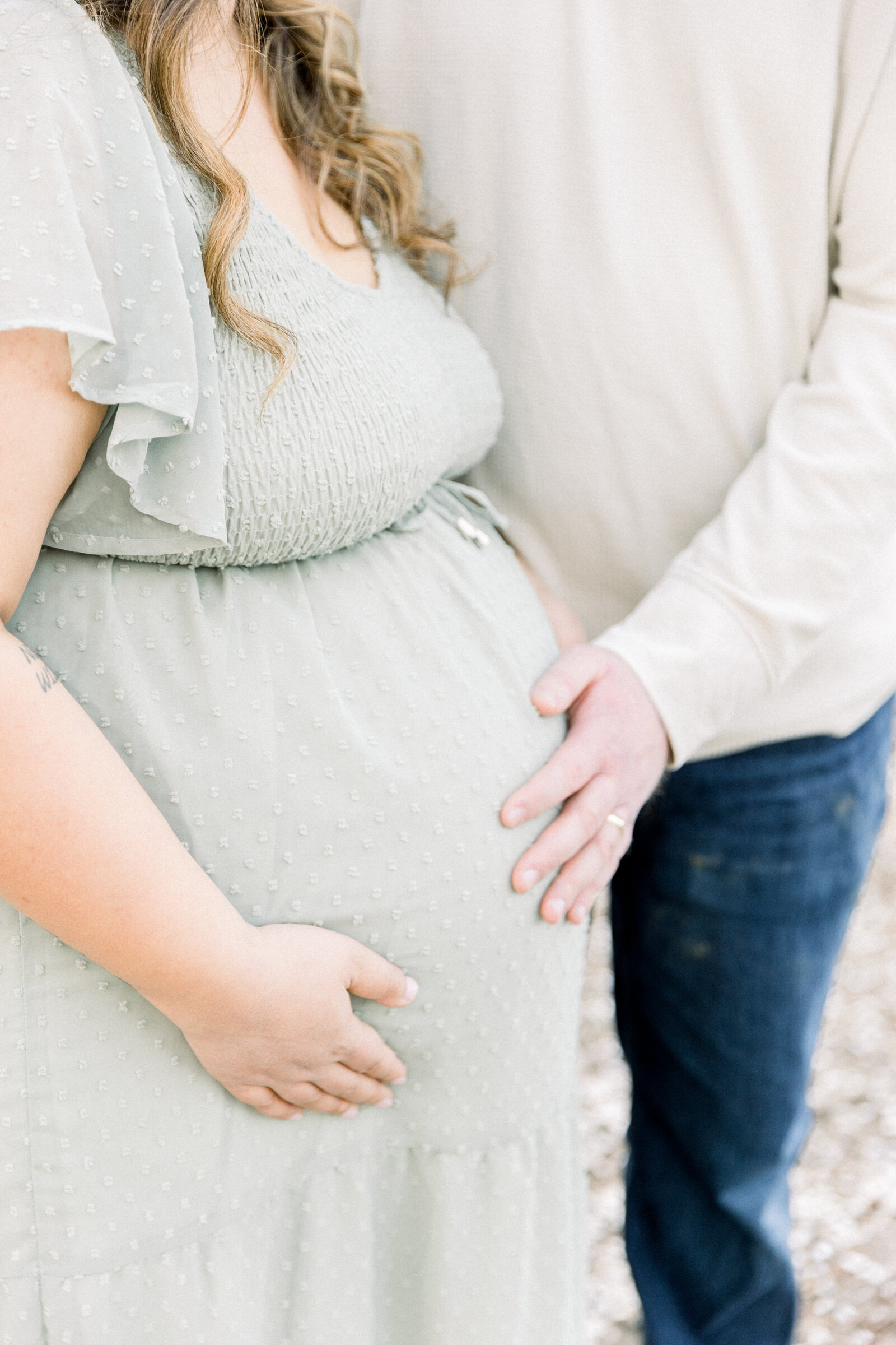 Image of expecting parents holding belly taken by Sacramento Newborn Photographer Kelsey Krall