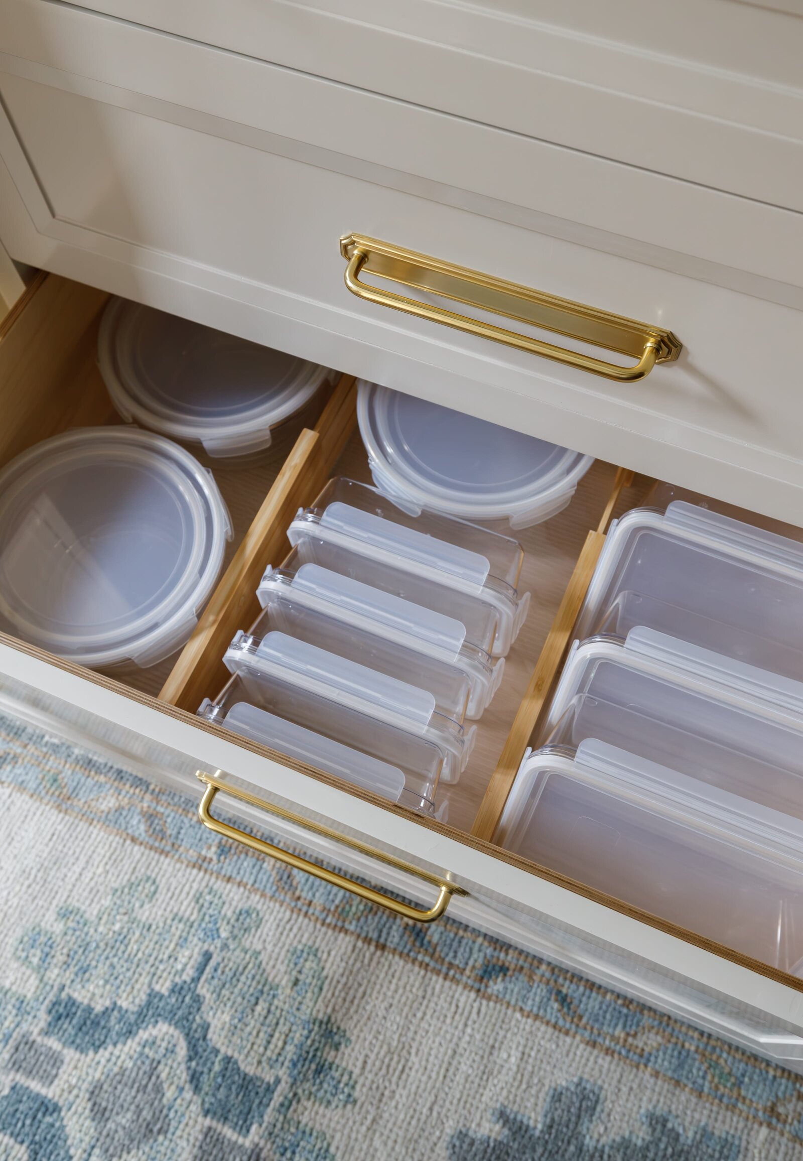 vision and hammer organizing tupperware in kithcen drawer