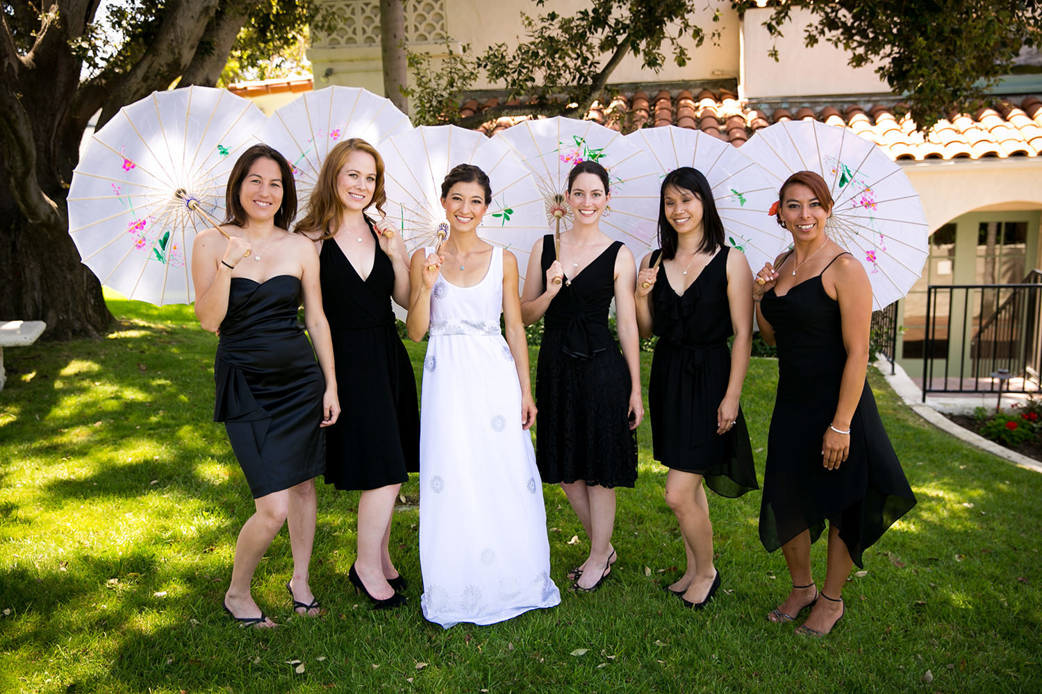 bride with bridesmaids and black umbrellas
