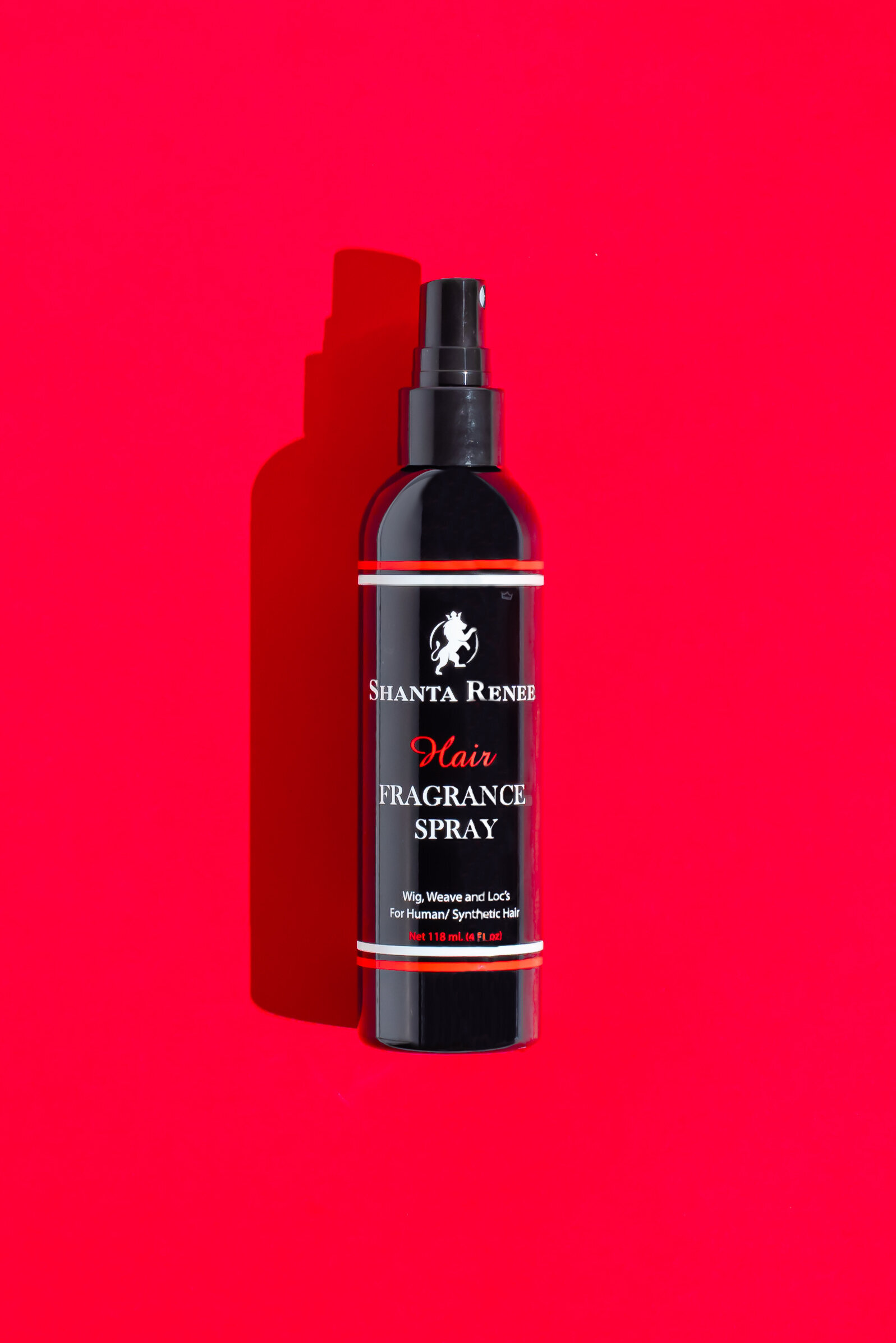 Bottle of hair fragrance on red background