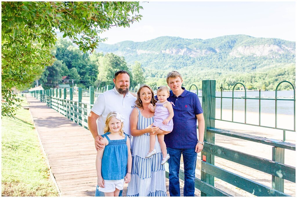 family with blue and white colors posed in front of Lake Lure