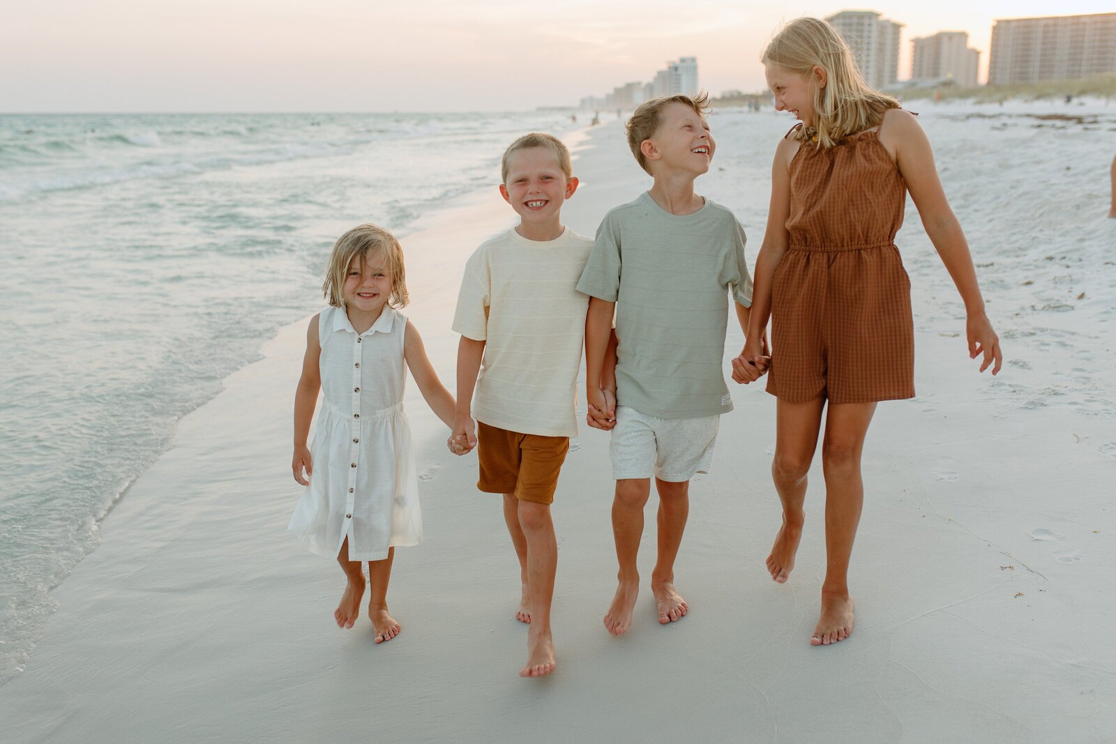 Pensacola Beach vacation family photography session .  Family  playing on the beach.