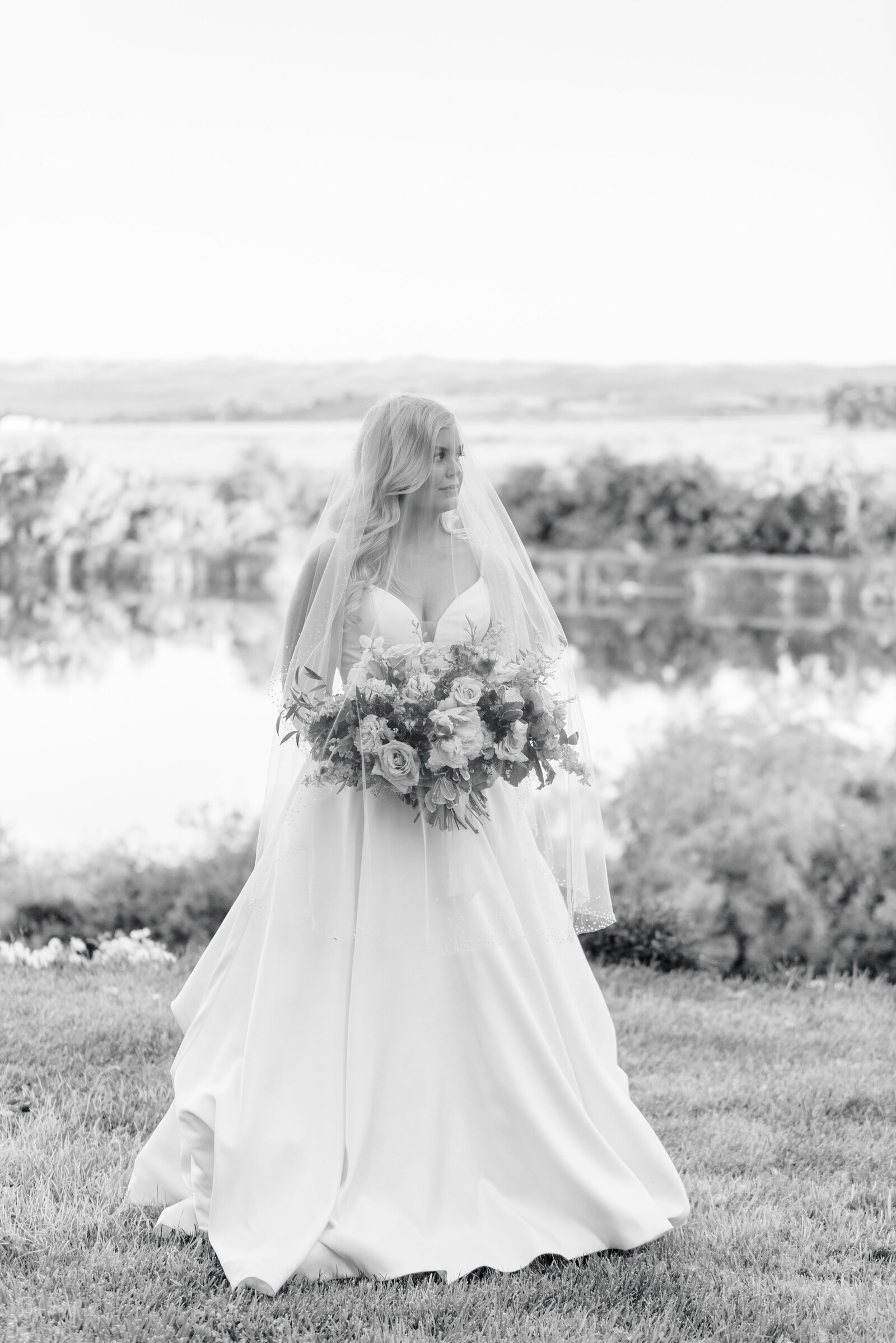 Bridal portrait in black and white with veil over bouquet taken by Best Boise Wedding Photographers