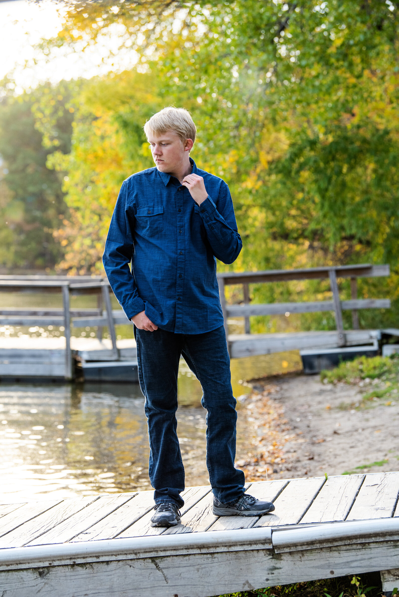 St. Anthony Village Minnesota high school senior wearing a casual outfit on the dock in nature