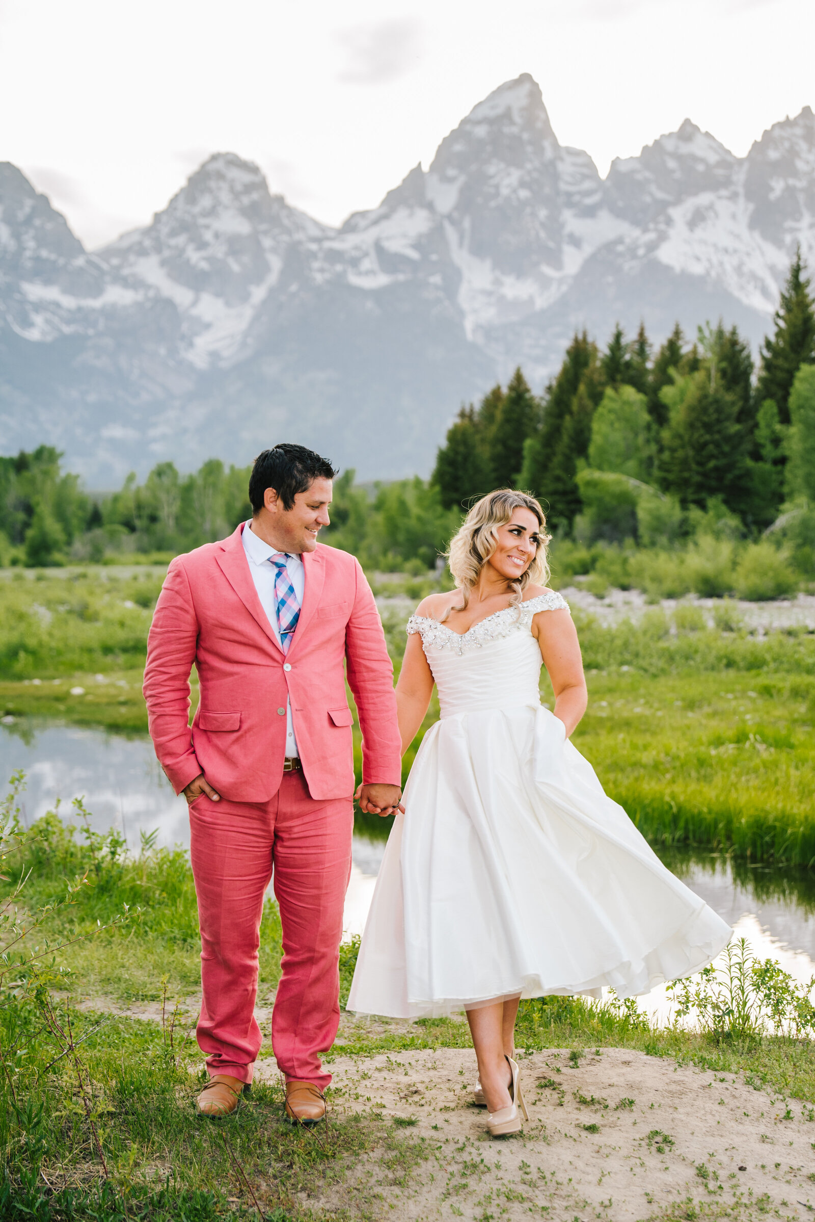 Jackson Hole wedding photographers capture couple walking hand in hand through Grand Teton National Park