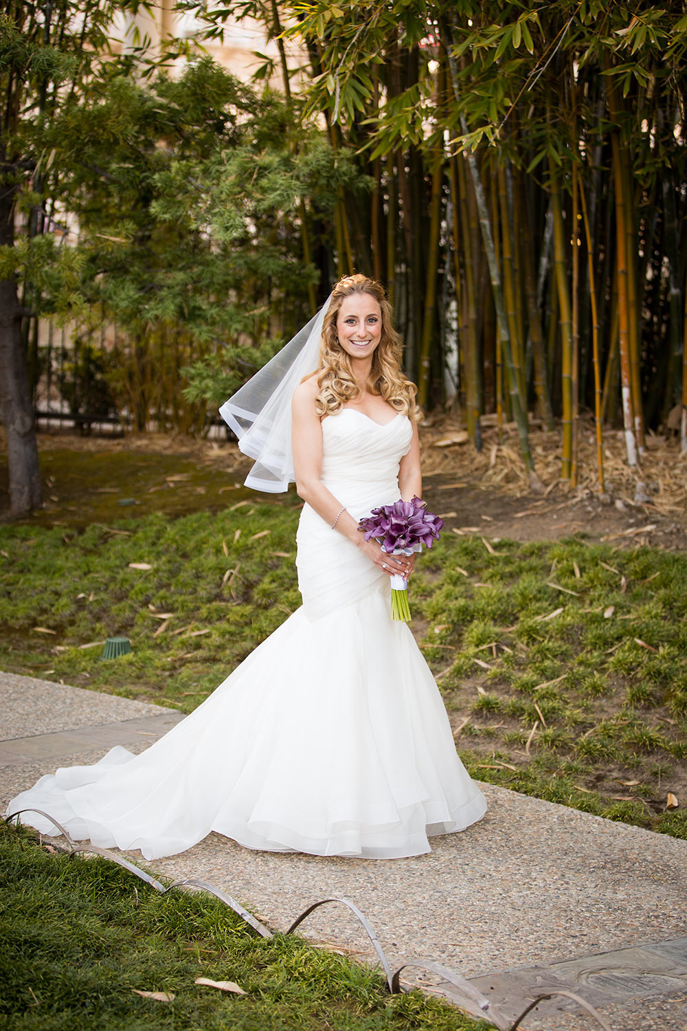 bride smiling with veil blowing
