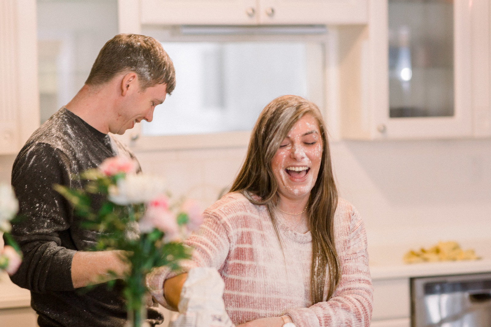 Couple playing in the kitchen captured by Staci Addison Photography