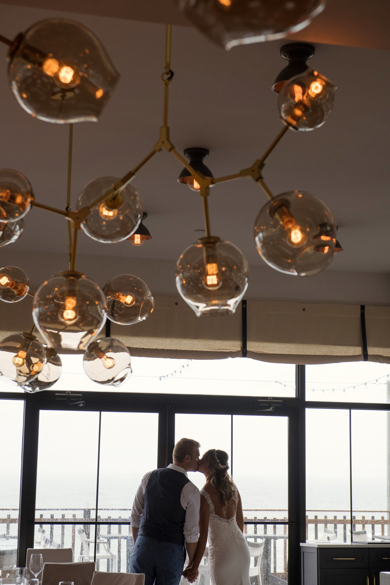 photo of bride and groom kissing inside Gurneys Montauk Resort wedding