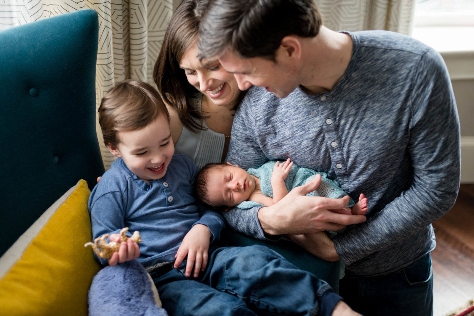 Family looking at newborn at home