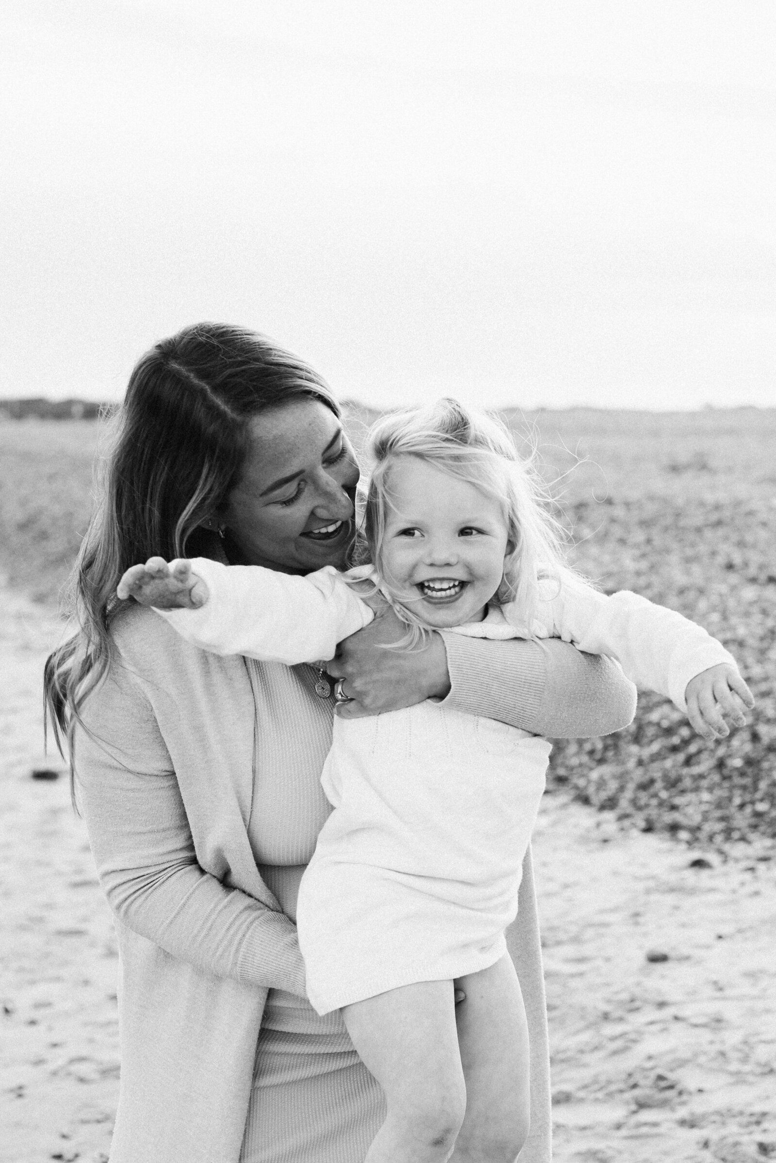 Mother holding daughter smiling at family photoshoot in goring west sussex