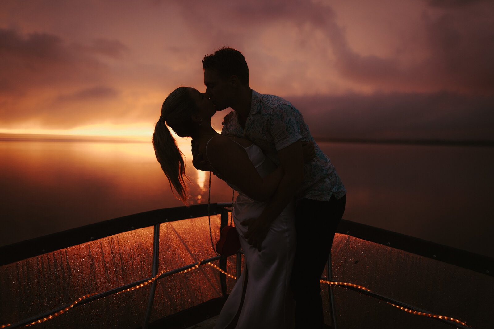 A couple embracing on a boat in Clear Lake Manitoba