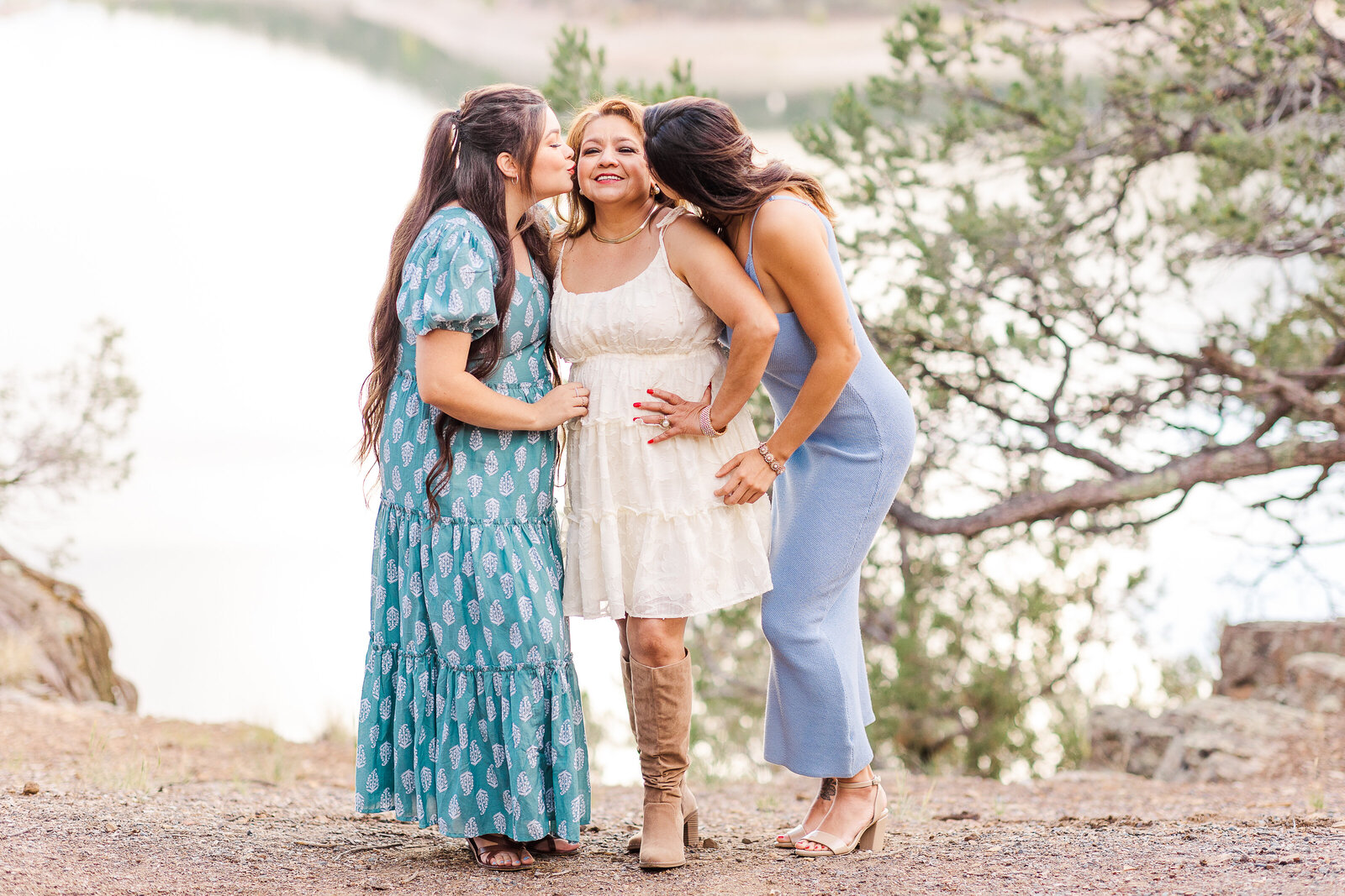 Daughters kiss mom on the cheek