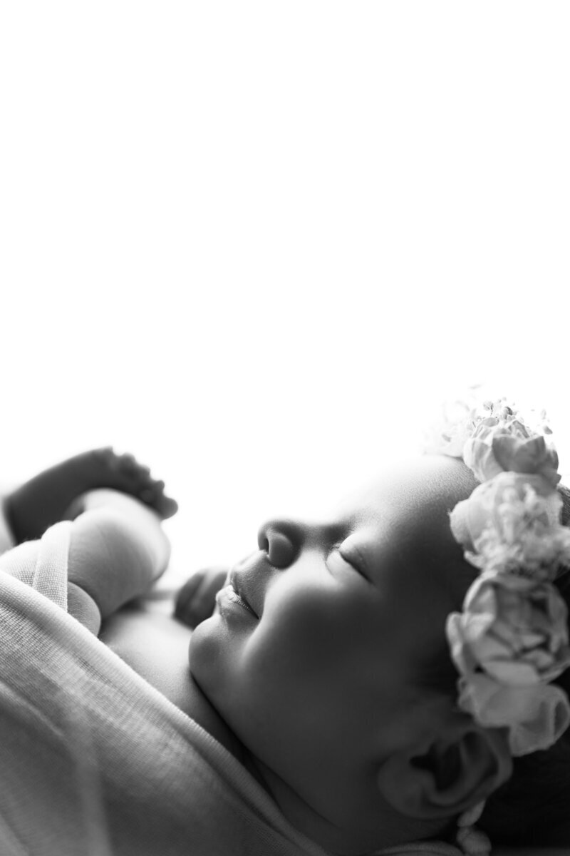 Newborn baby side profile smiling by best newborn photographers nj
