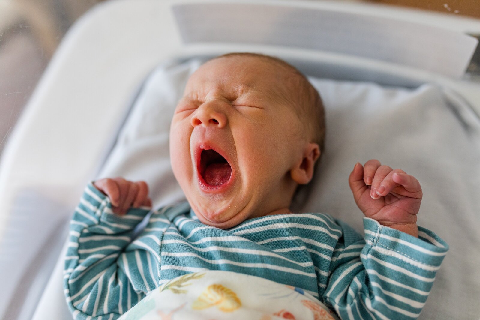 Newborn photography session baby yawning