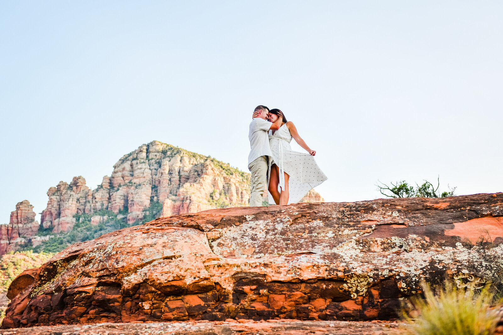 Sedona engagement couple dress red rocks holding each other