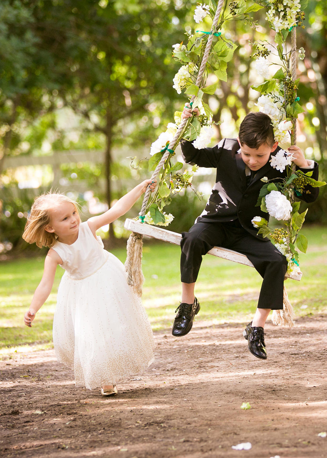 Hilarious moment with the flower girl and ring bearer on the swing at Green Gables