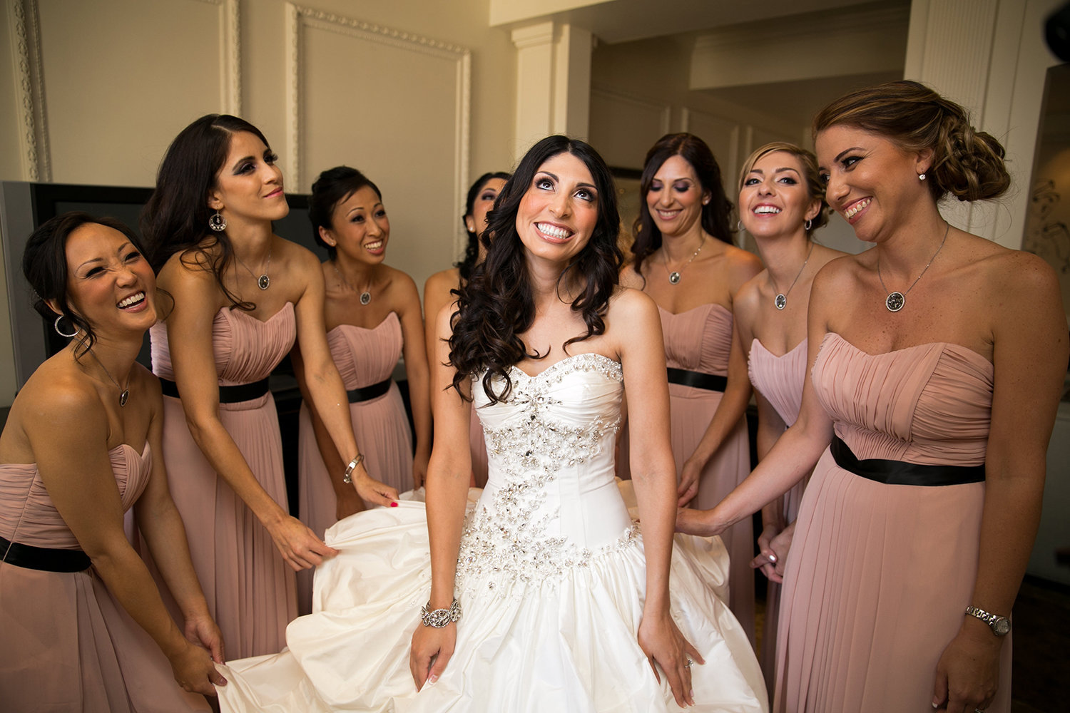 Great natural moment photo of bride and bridesmaids getting ready at a wedding