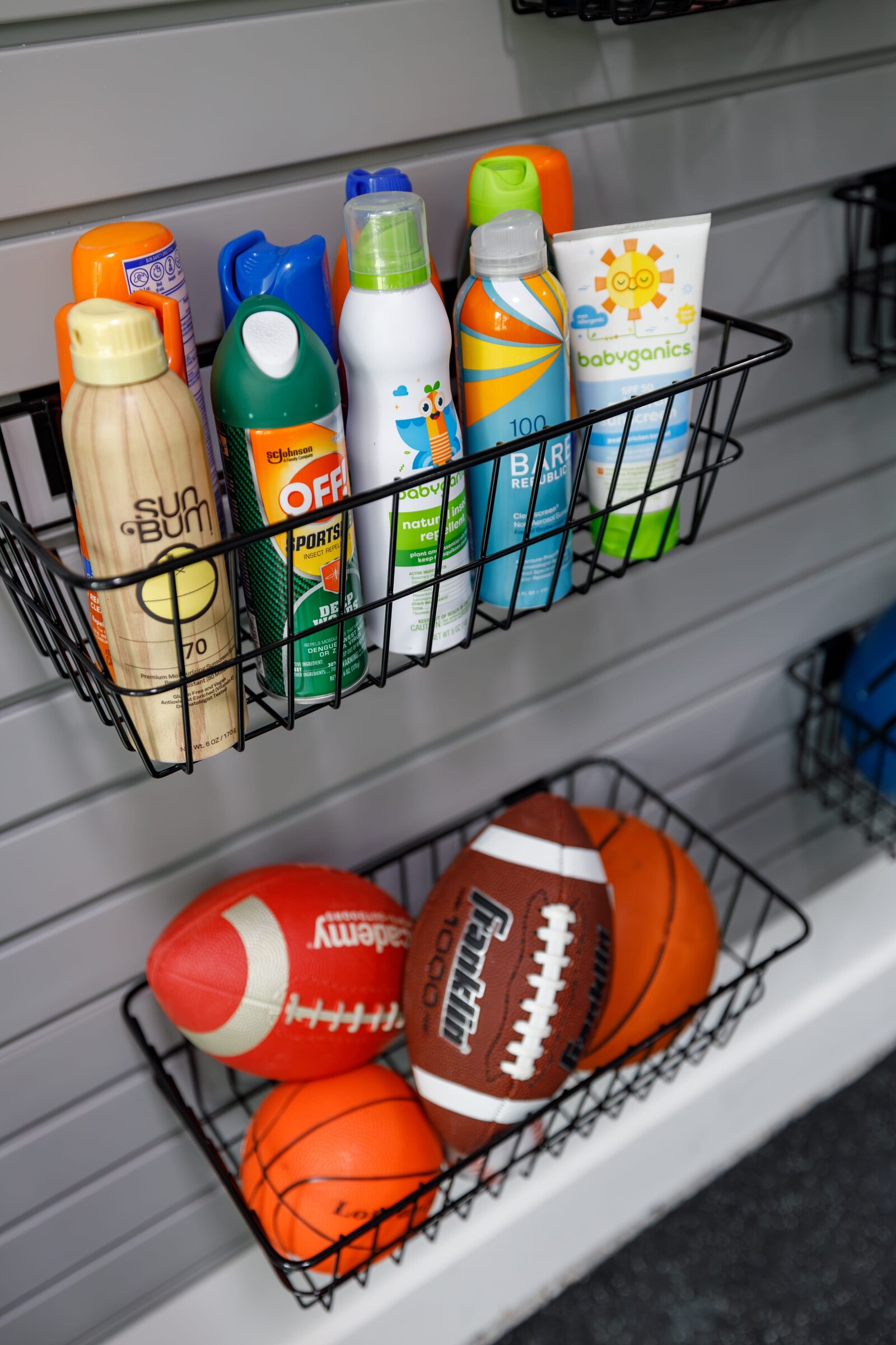 vision and hammer organizing garage baskets with footballs and sunscreen