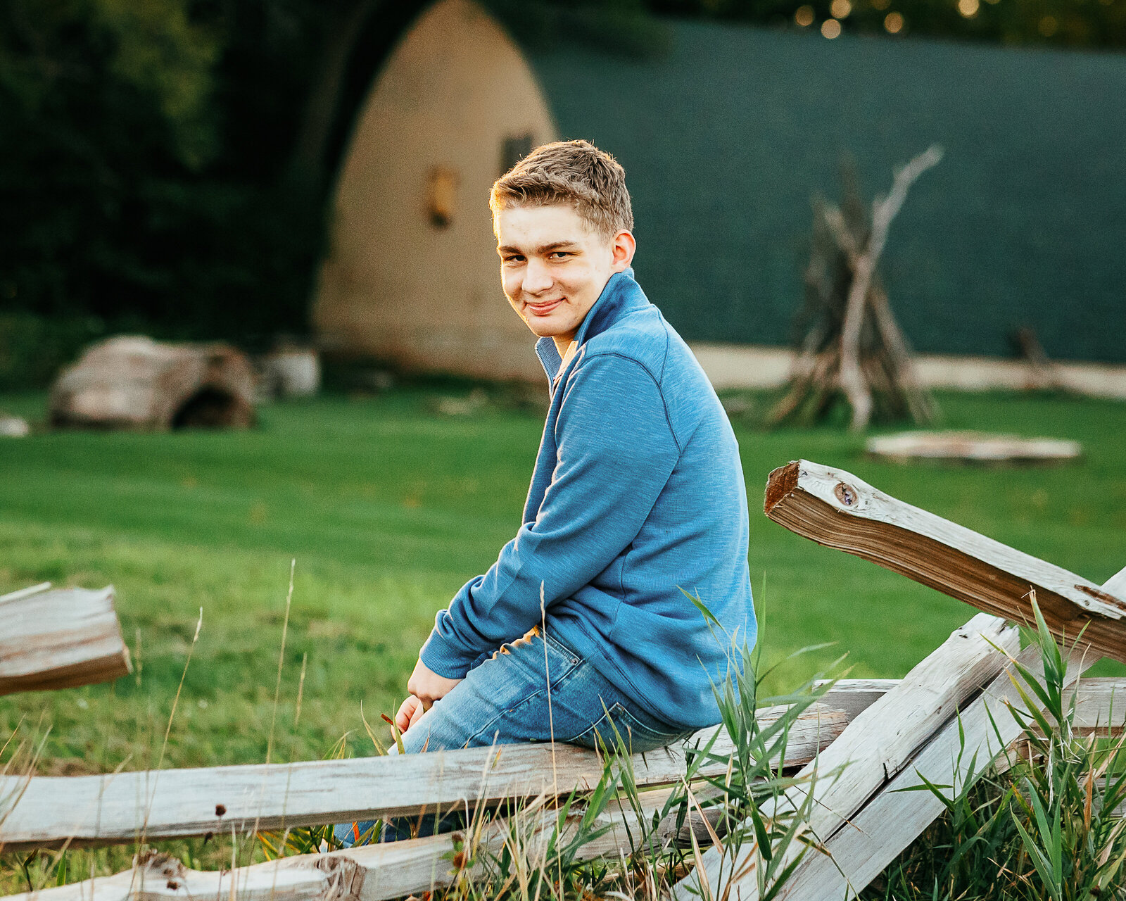 Senior Boy sitting on wood fence