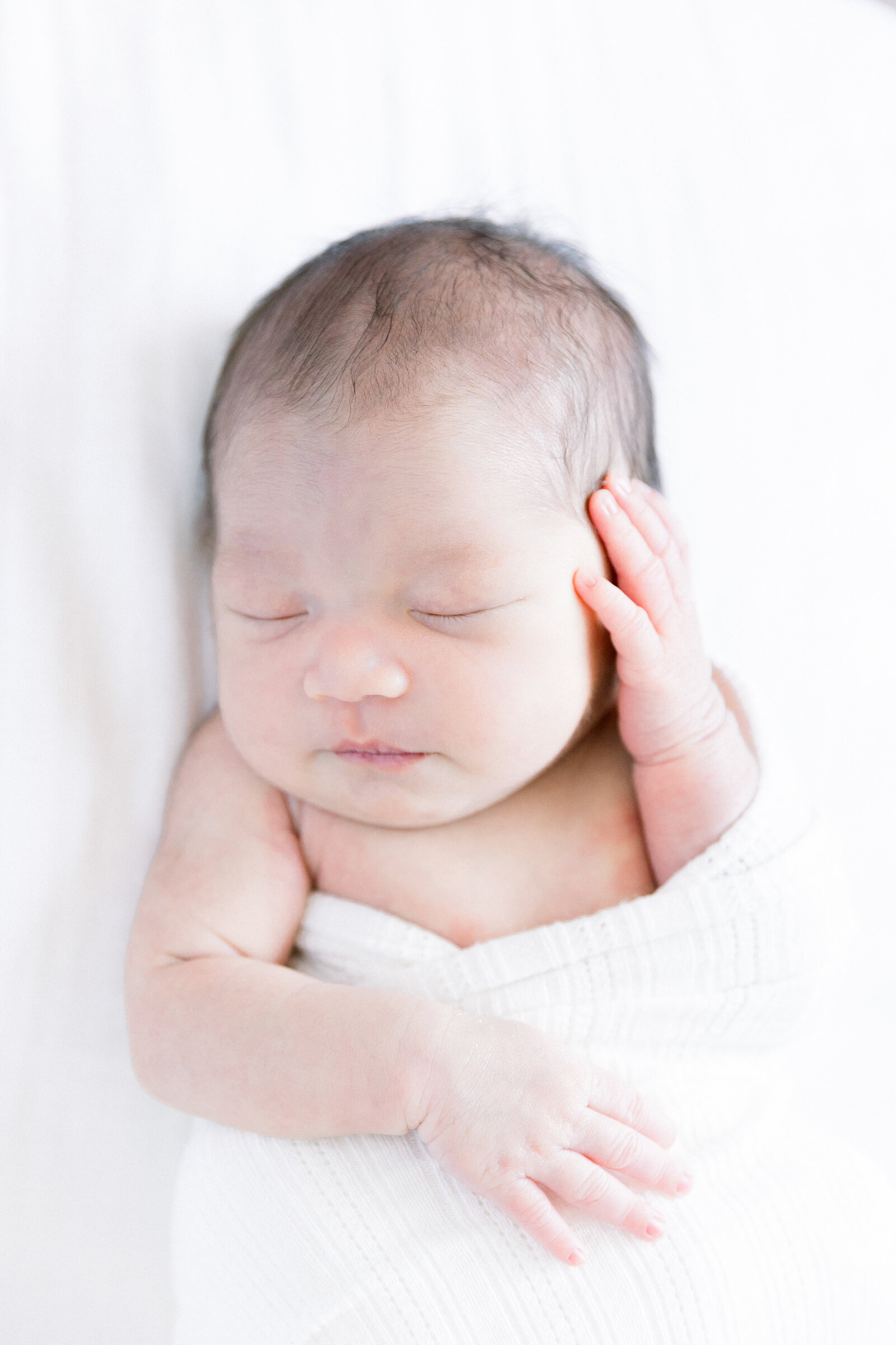 Image of sleeping baby with hand on face taken by Sacramento Newborn Photographer Kelsey krall