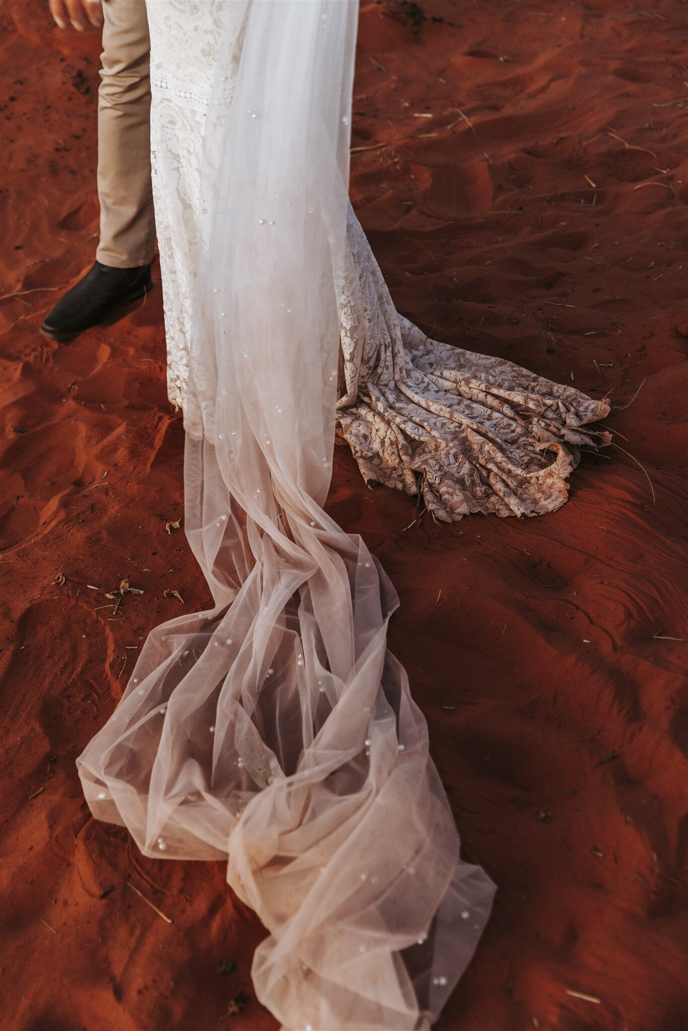 A wedding dress train in the desert at an Uluru wedding