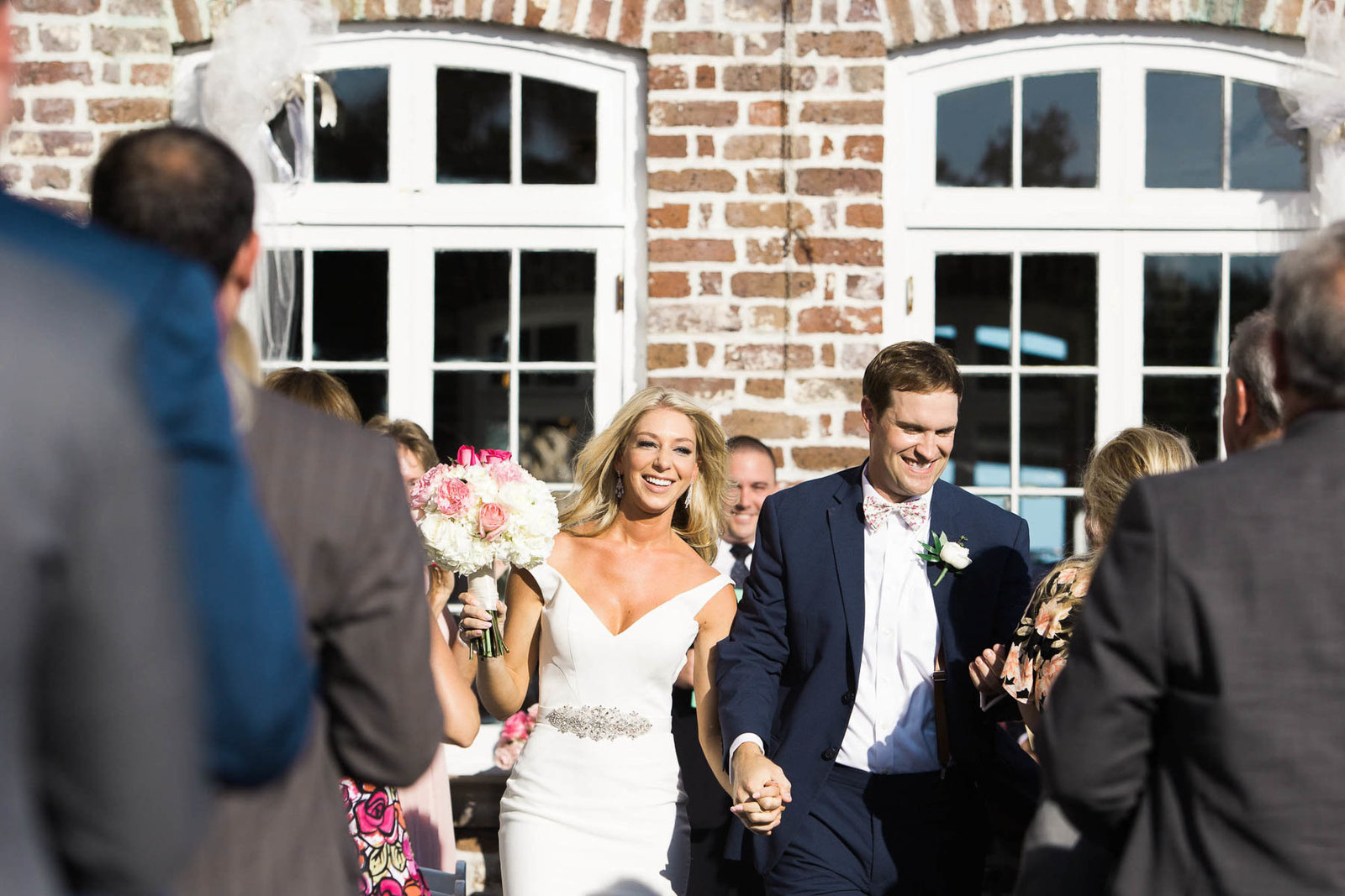 Bride and groom walk down the aisle, Rice Mill Building, Charleston Wedding Photographer.