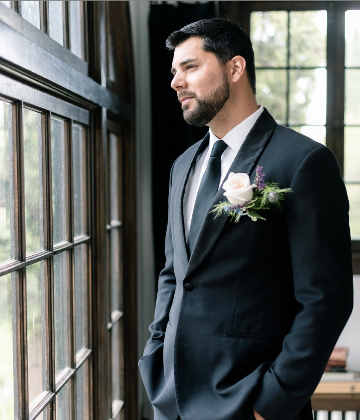 Groom waiting for the first look in front of the windows at Cottage at Riverbend Wedding by the Best Boise Wedding Photographers