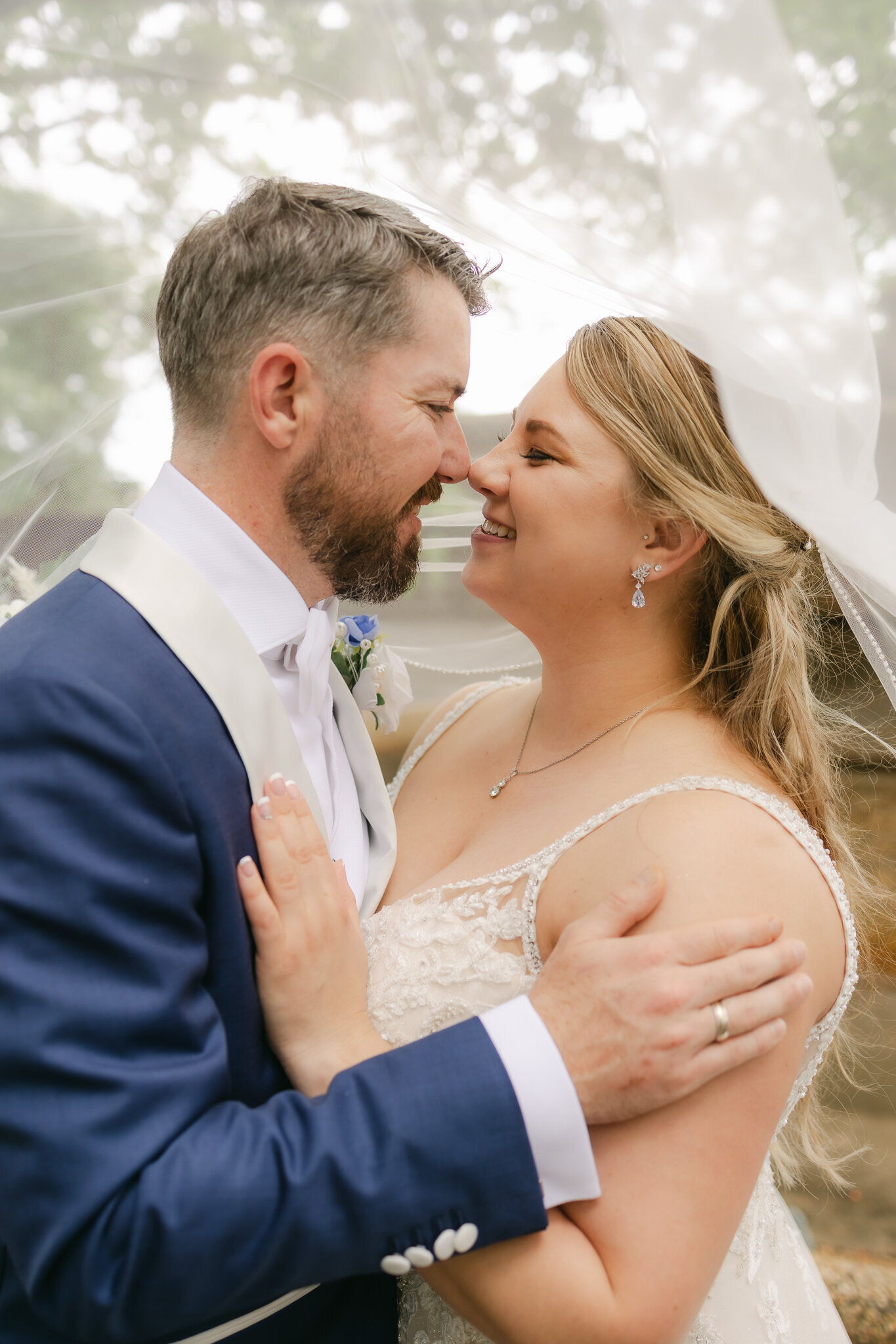 Wedding couple gazes lovingly under a veil