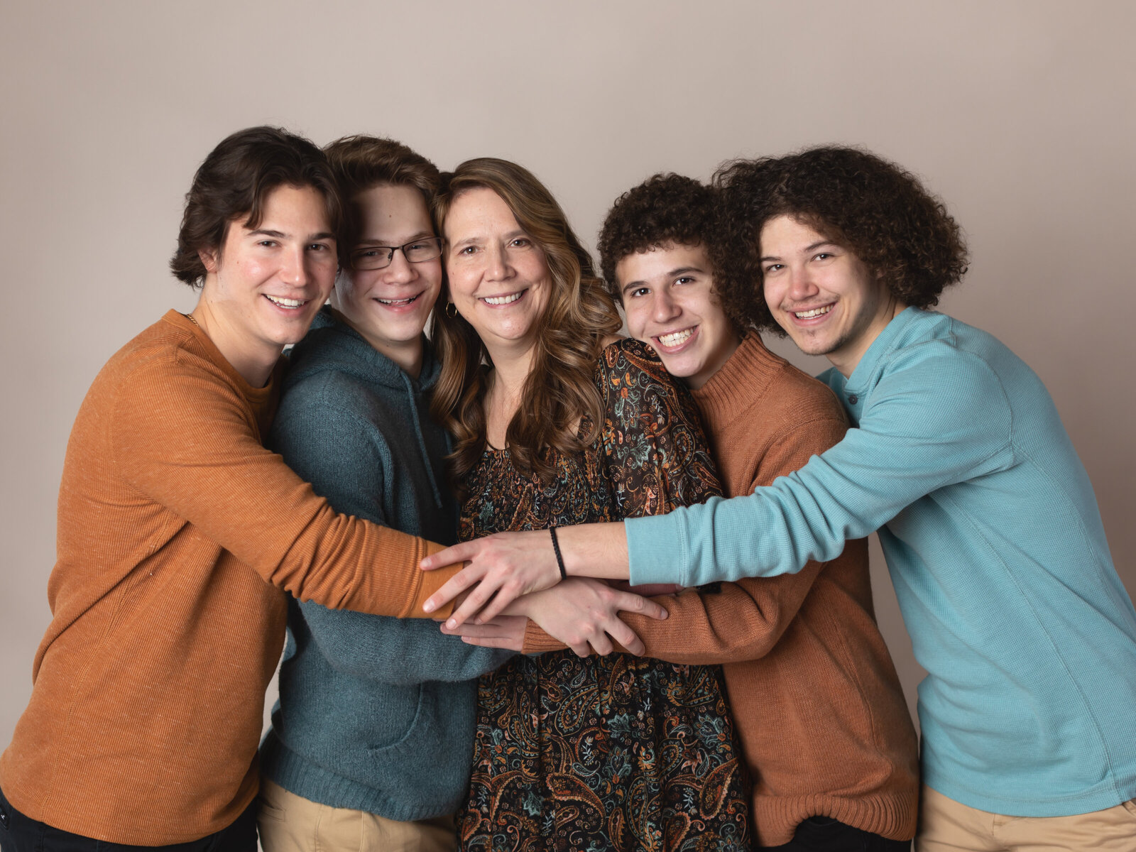 four brothers and sister posed for studio family portraits