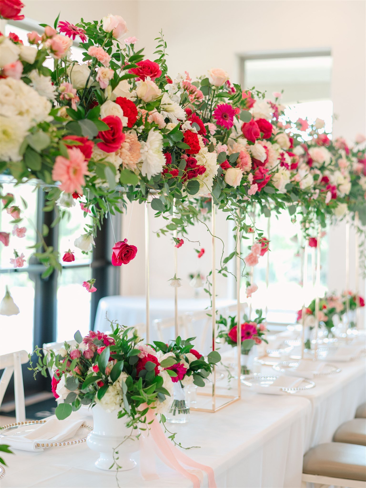 luxury wedding display with white, pink and red flowers