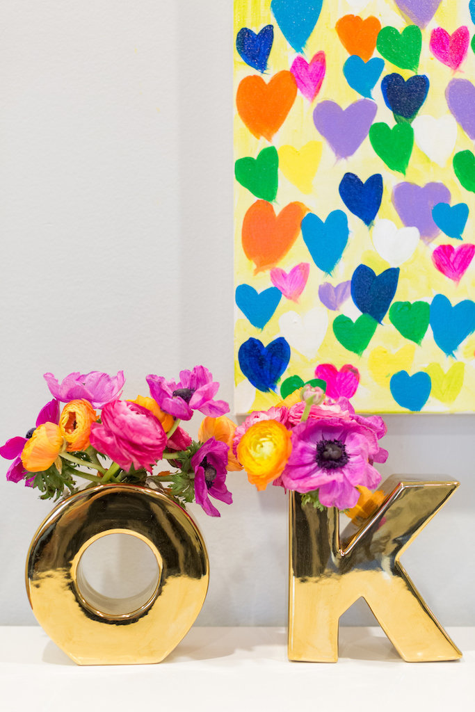 Gold O and K vases with bright flower and colorful heart painting.