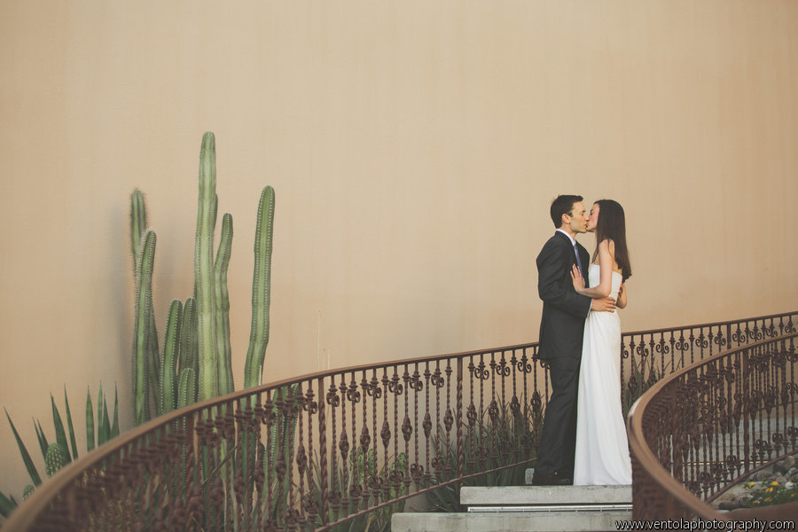 newlyweds kissing in the phoenician cactus garden