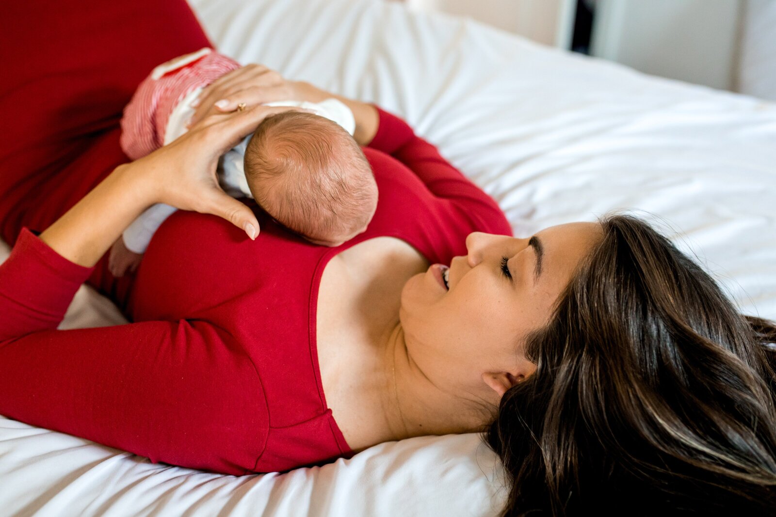 Newborn lying on mom's chest during newborn photography session.