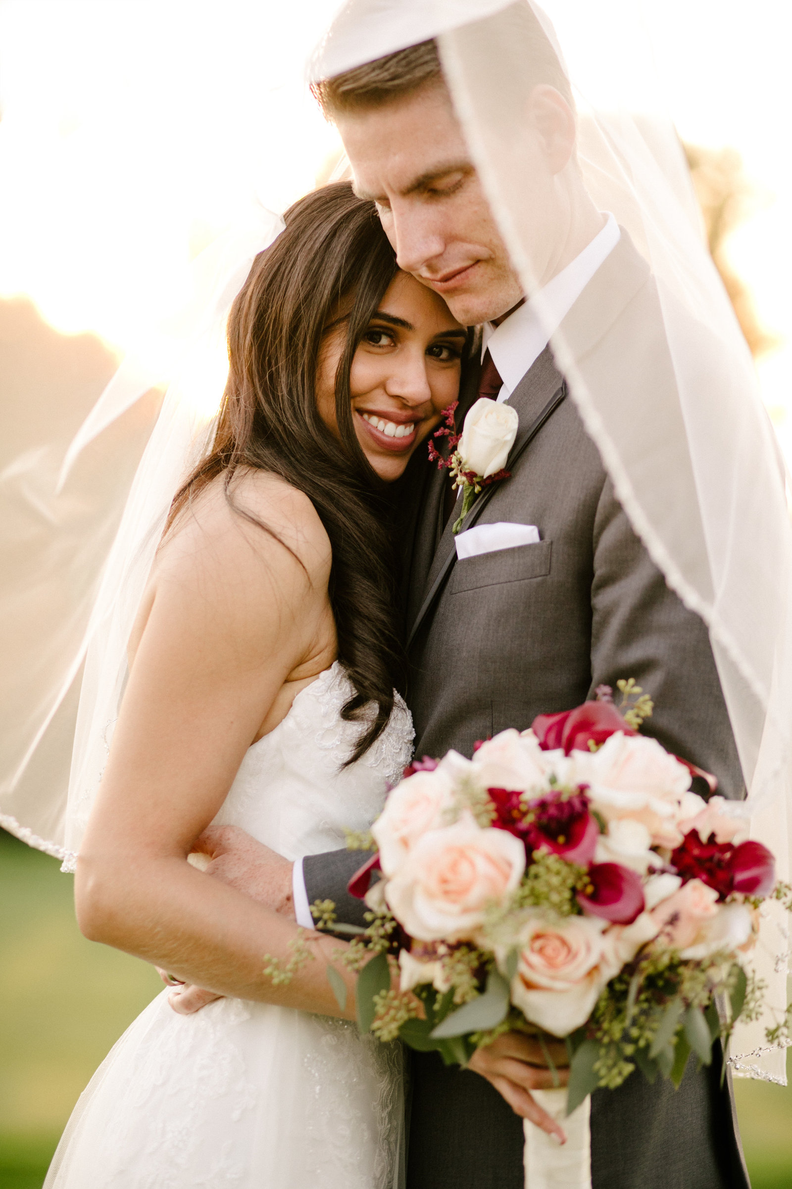 bride and groom holding each other at red hill country club in rancho cucamonga