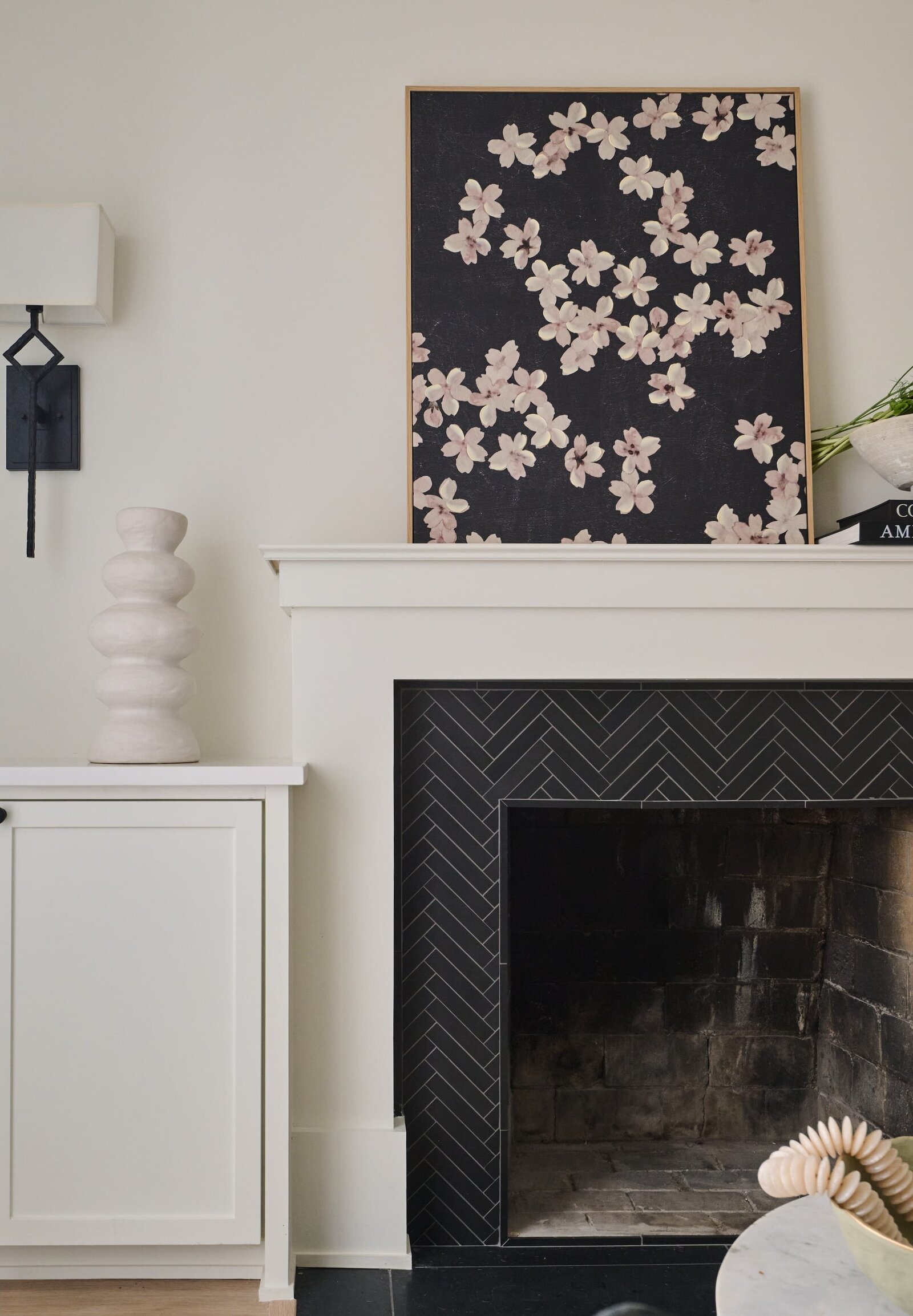 cocoloba homes graham living room fireplace with flower painting on mantle