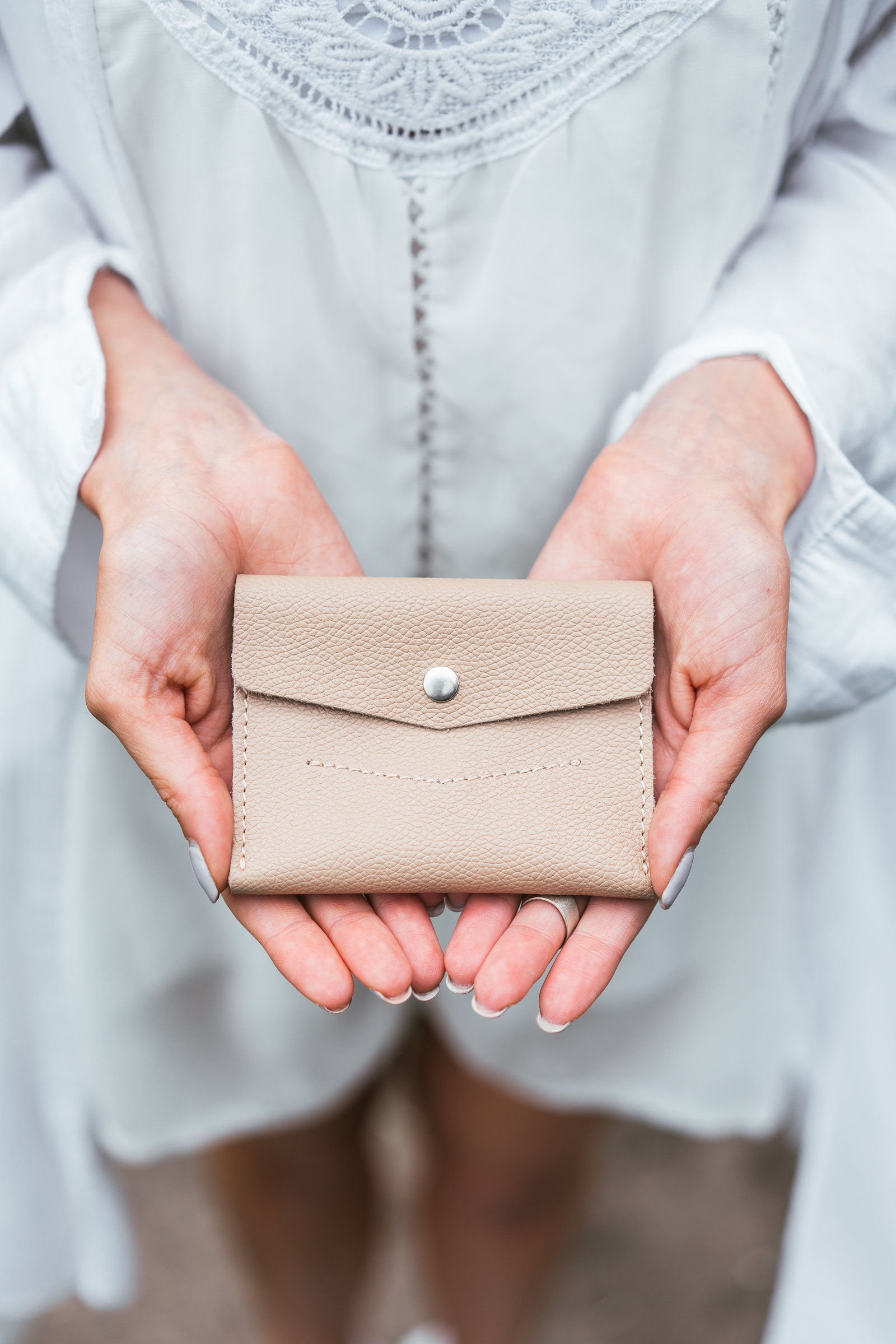 woman-hands-hold-purse-PTKC7UU