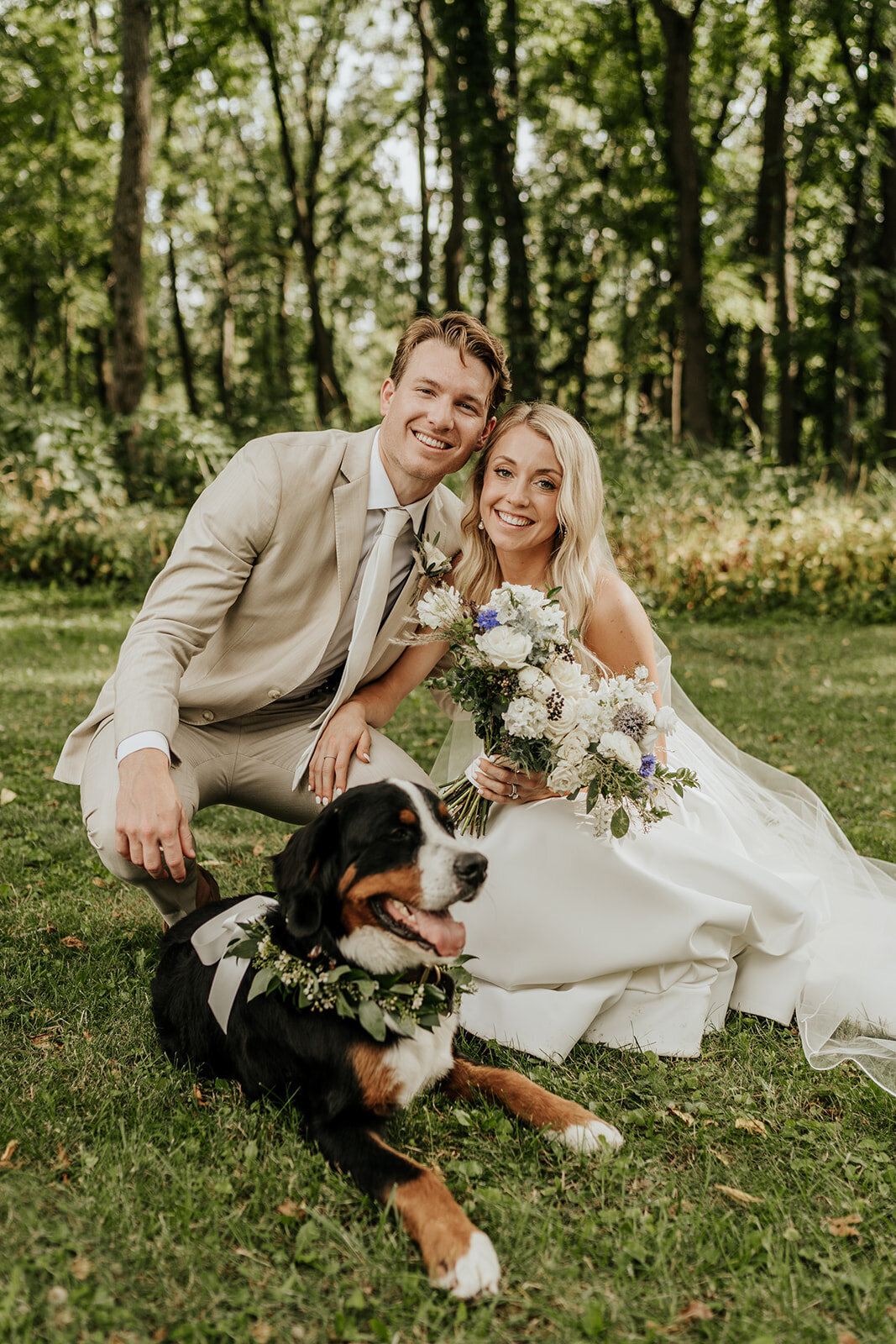 bride and groom with their dog at barnwood events, a wedding venue in madison, winconsin.