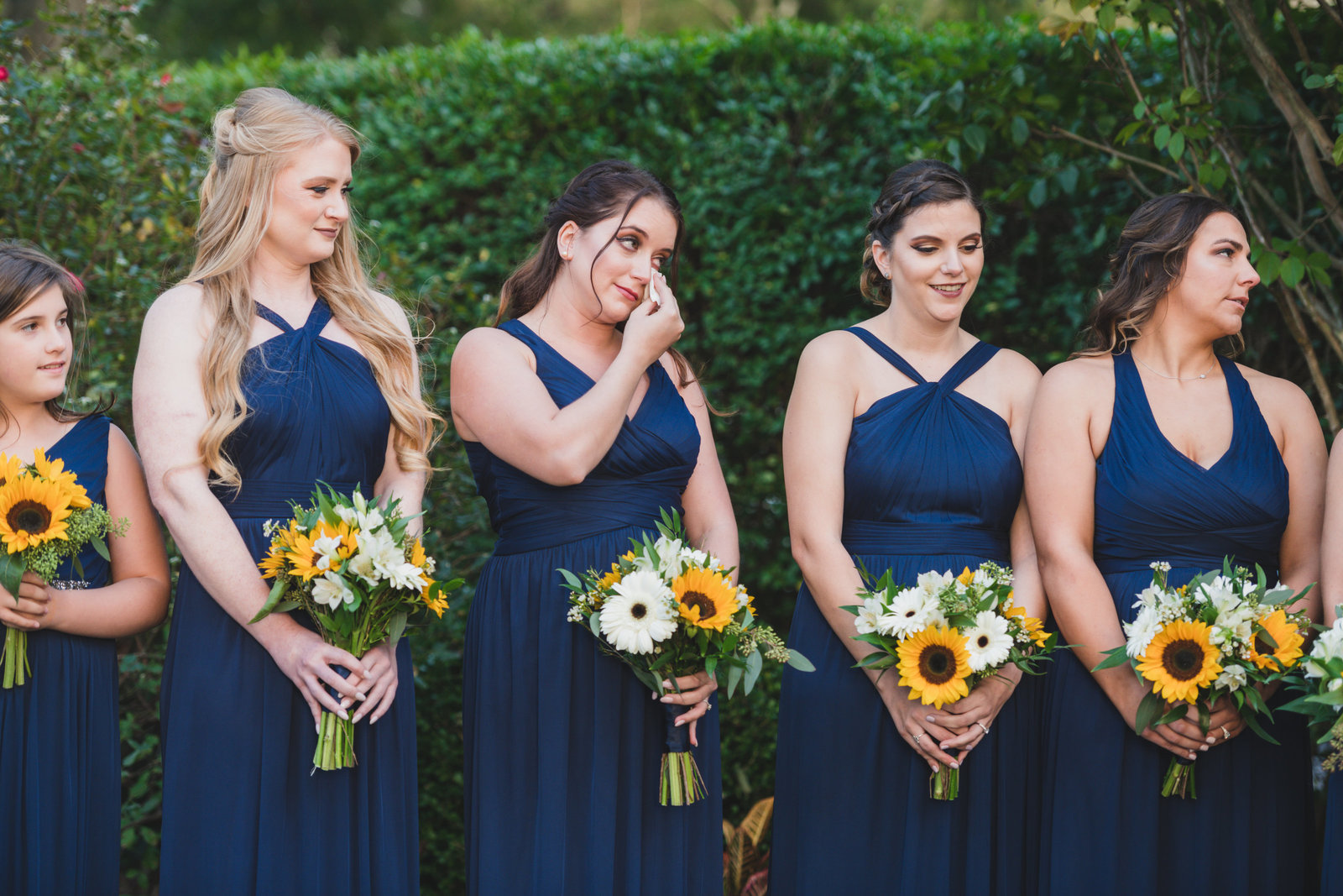 photo of emotional bridesmaids holding their bouquets from wedding at Three Village Inn