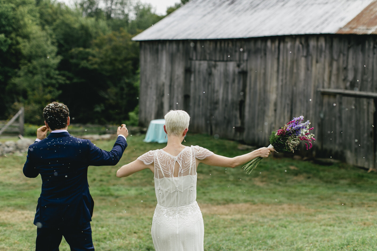 bride and groom celebrating at old barn
