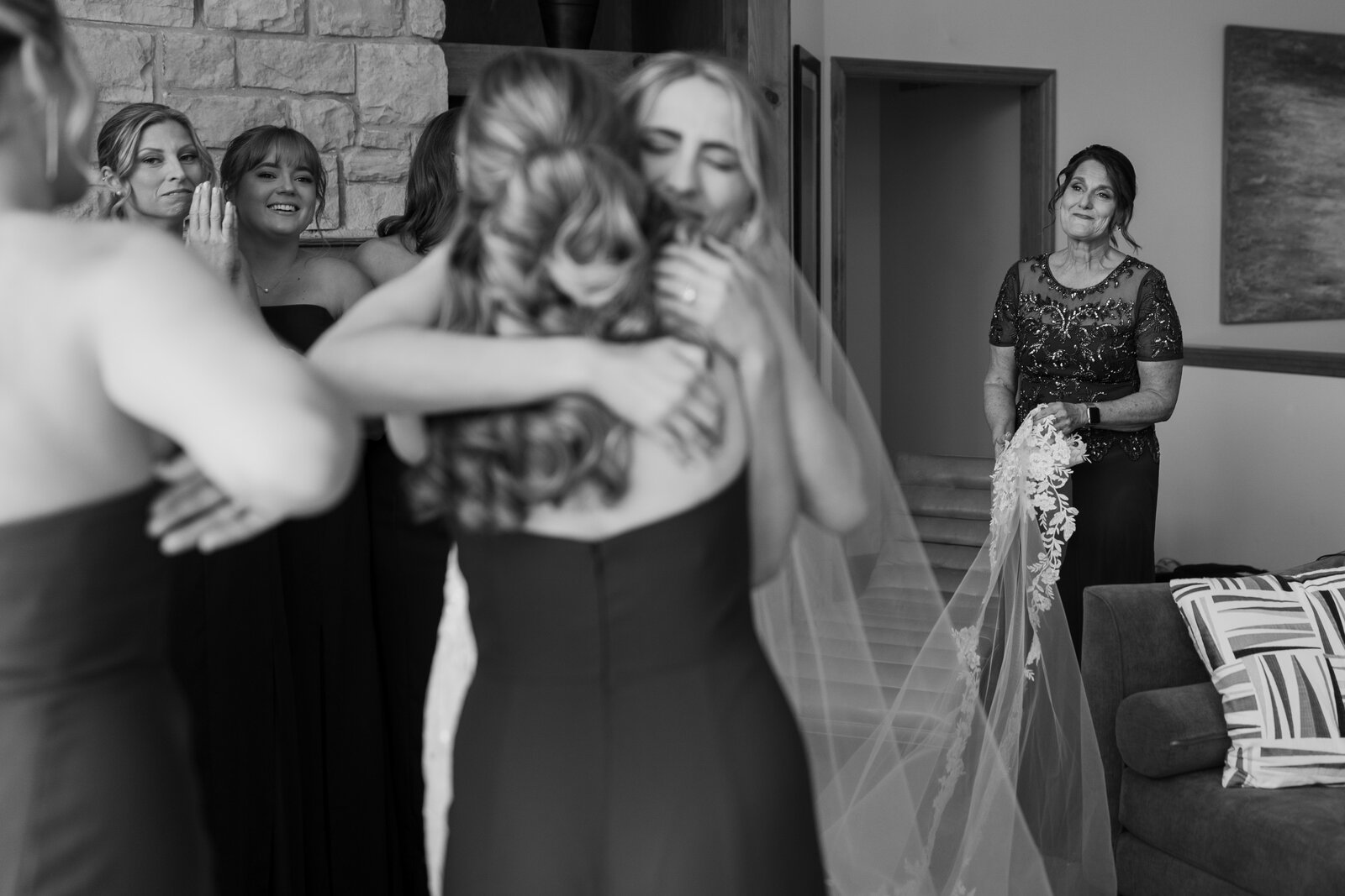 Mother of bride looking happy while bride giving hugs