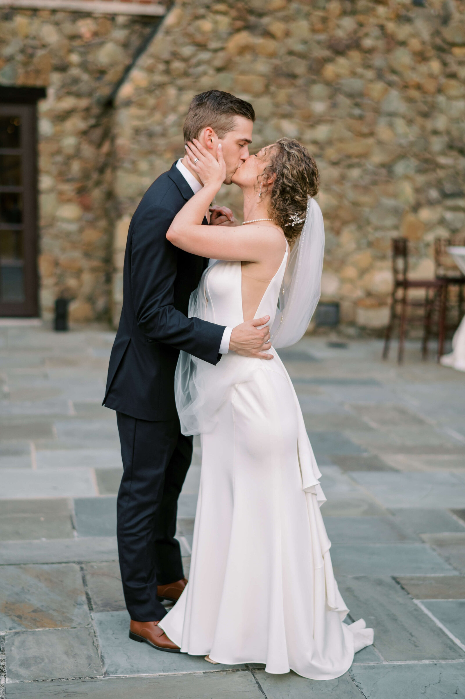 The bride and groom passionately kiss after their Virginia wedding