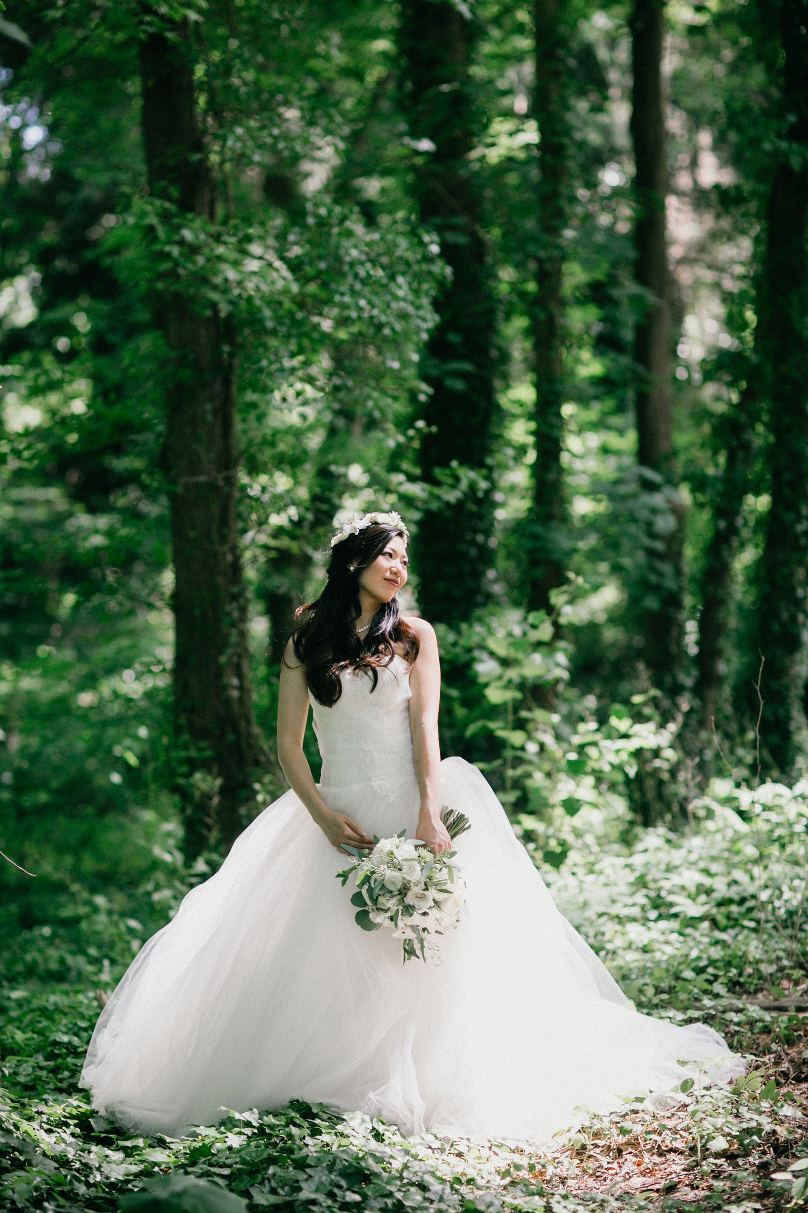 Gorgeous shot of the bride in her gown amongst the lush green trees of Fernbrook Farm Inn.