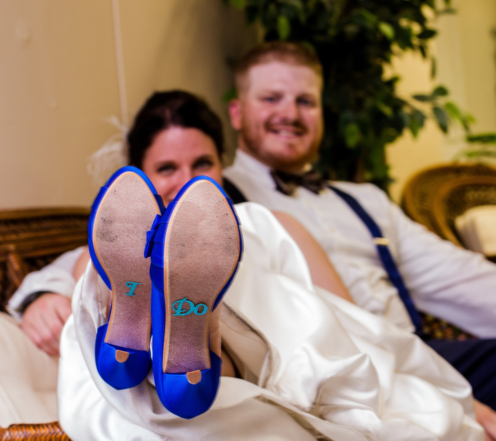 Bride and groom relax on a sofa during their Masonic Temple wedding reception in Erie, PA
