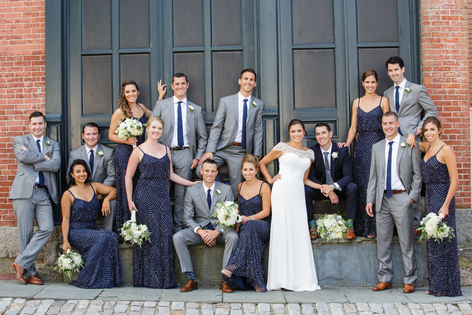 wedding party poses on city street